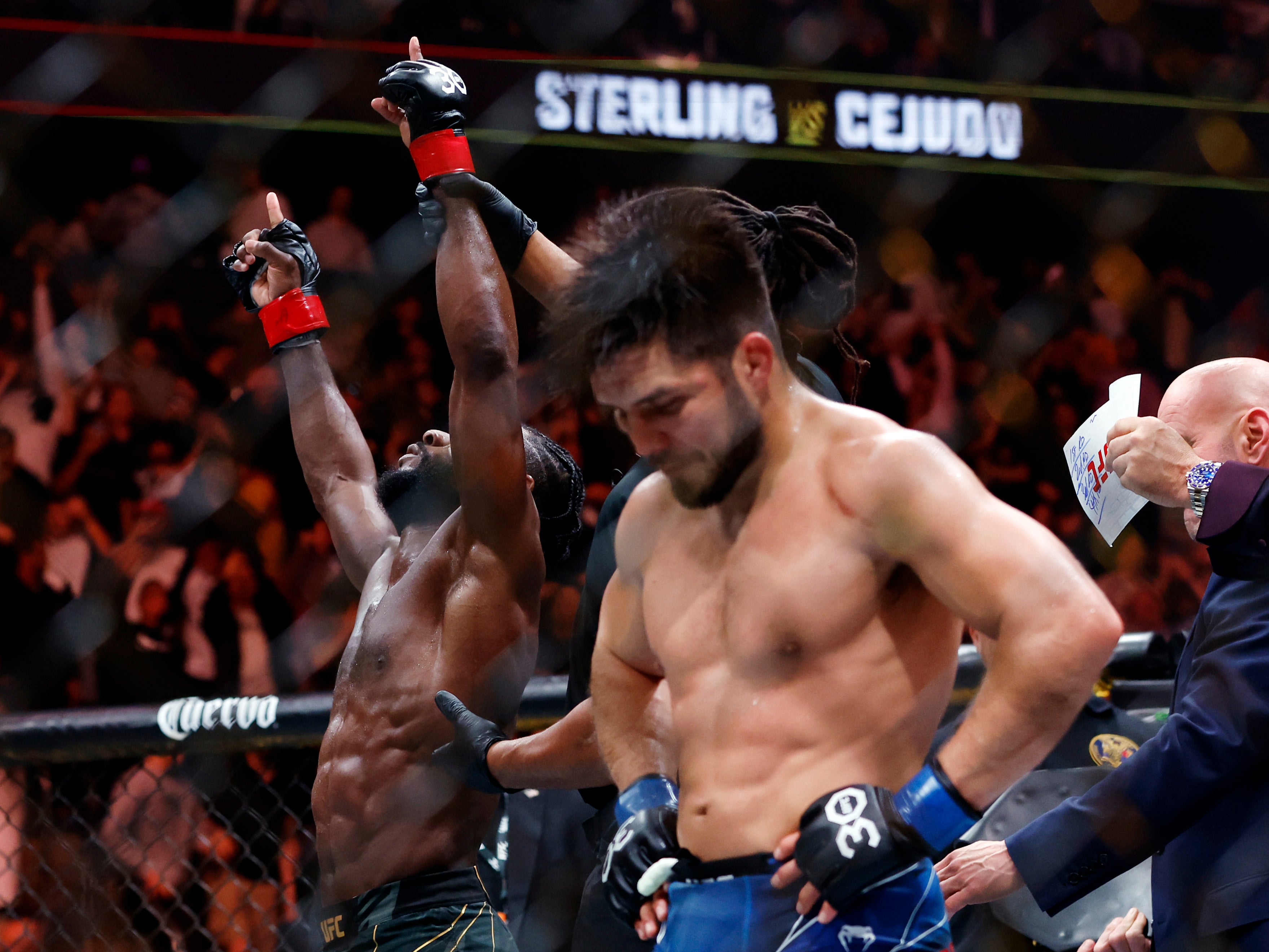 Henry Cejudo (right) reacts to his split-decision loss to Aljamain Sterling