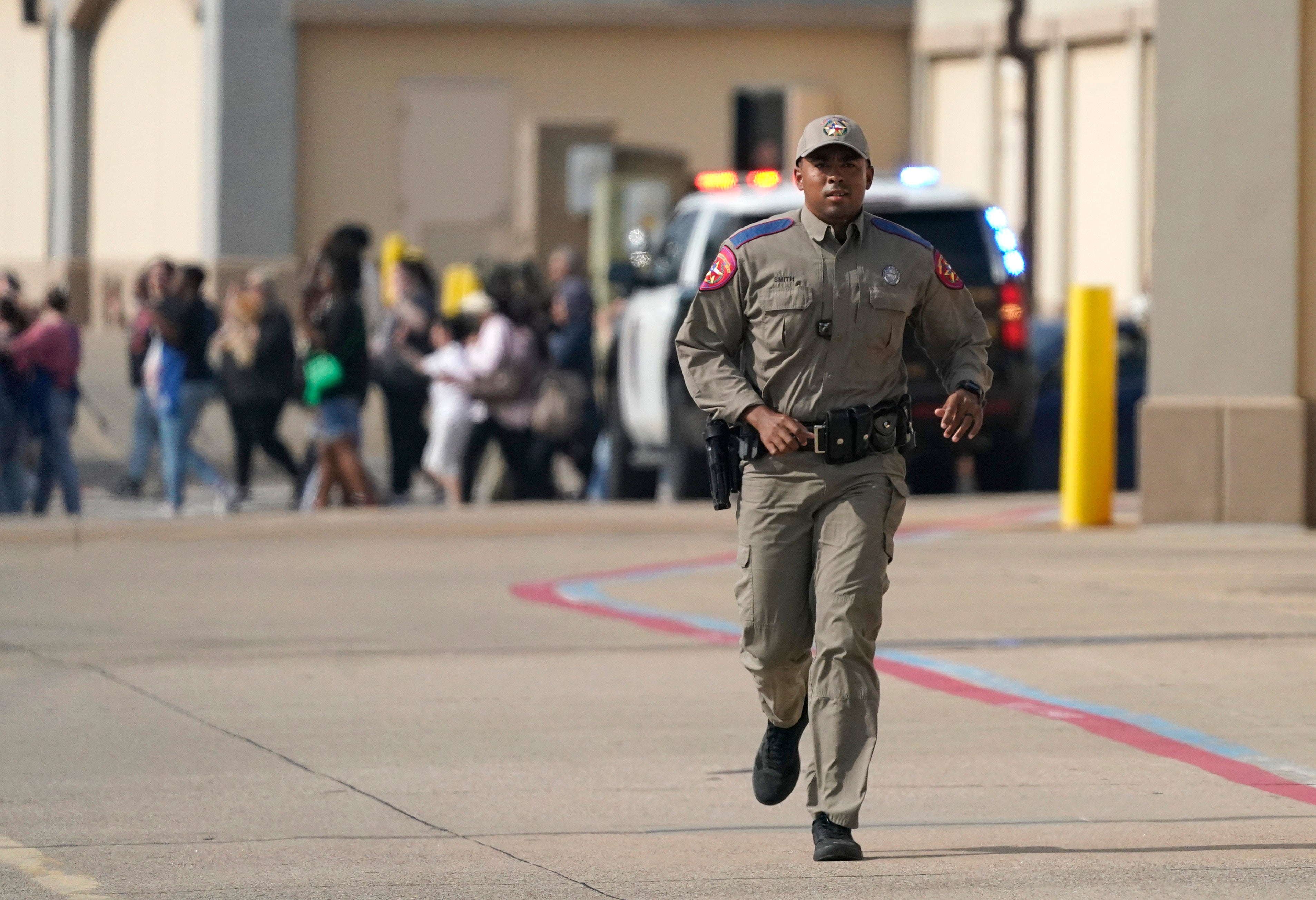 Police on the scene of the mass shooting at a mall in Allen