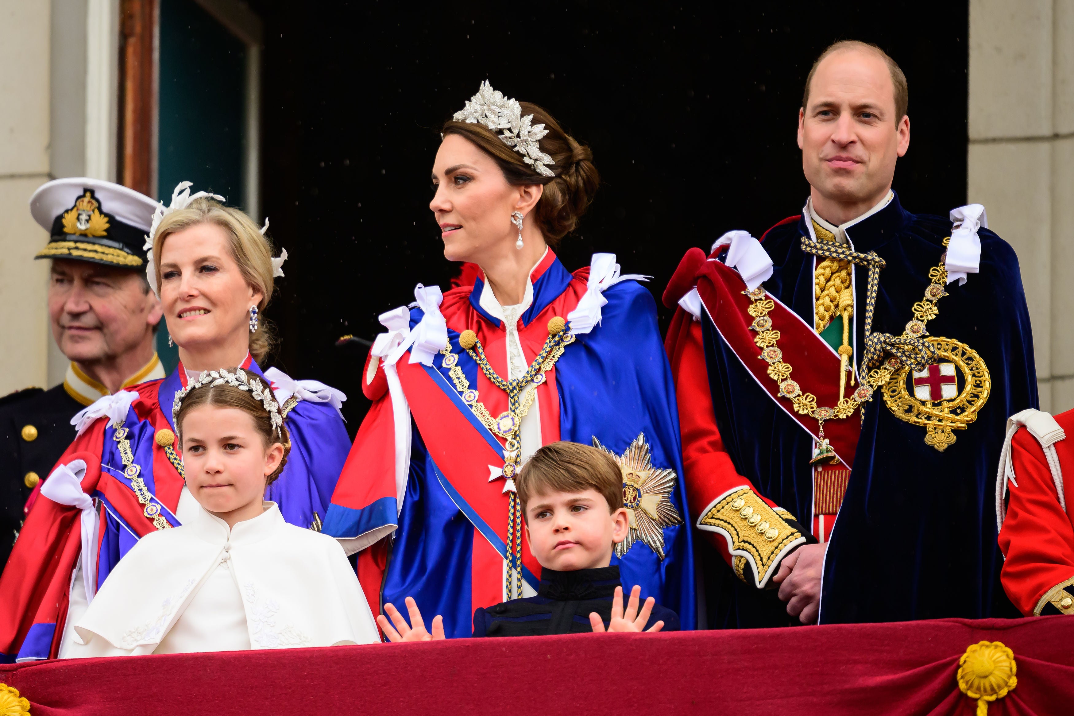 Prince Louis, five, gives an adorable two-handed wave to the crowds lining the Mall