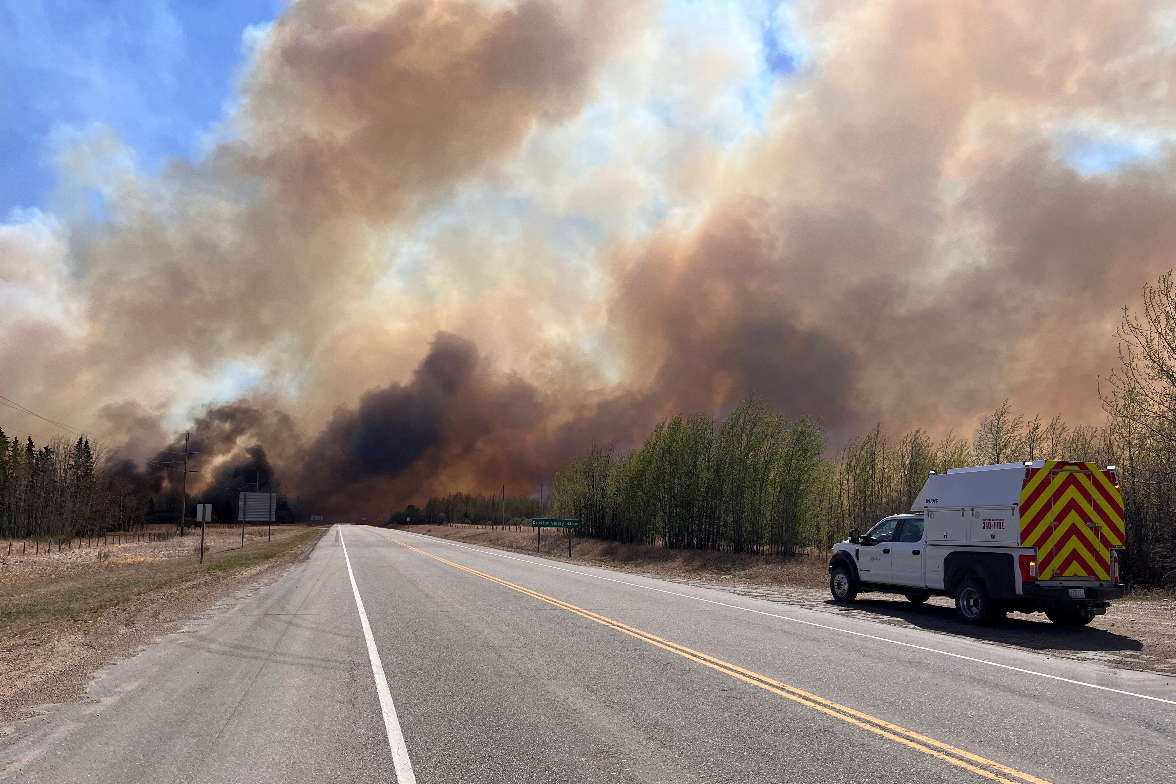 Wildfires leave sky thick with smoke as 25,000 forced to flee western Canada