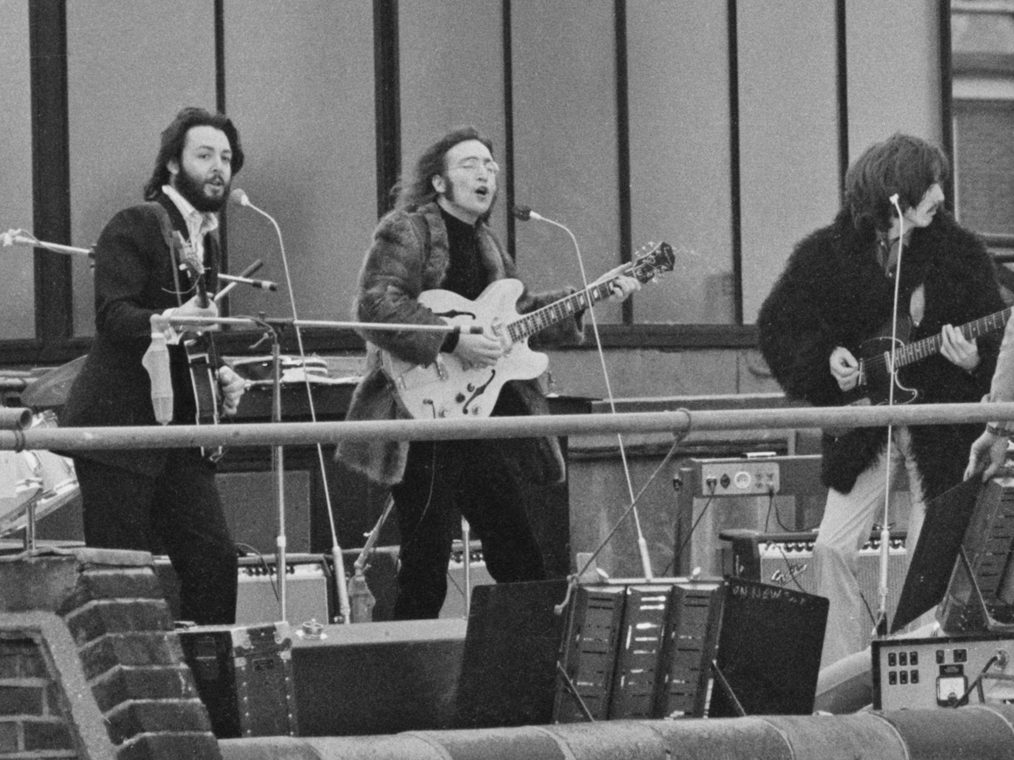 The band performing their last live public concert on the rooftop of the Apple Corps building