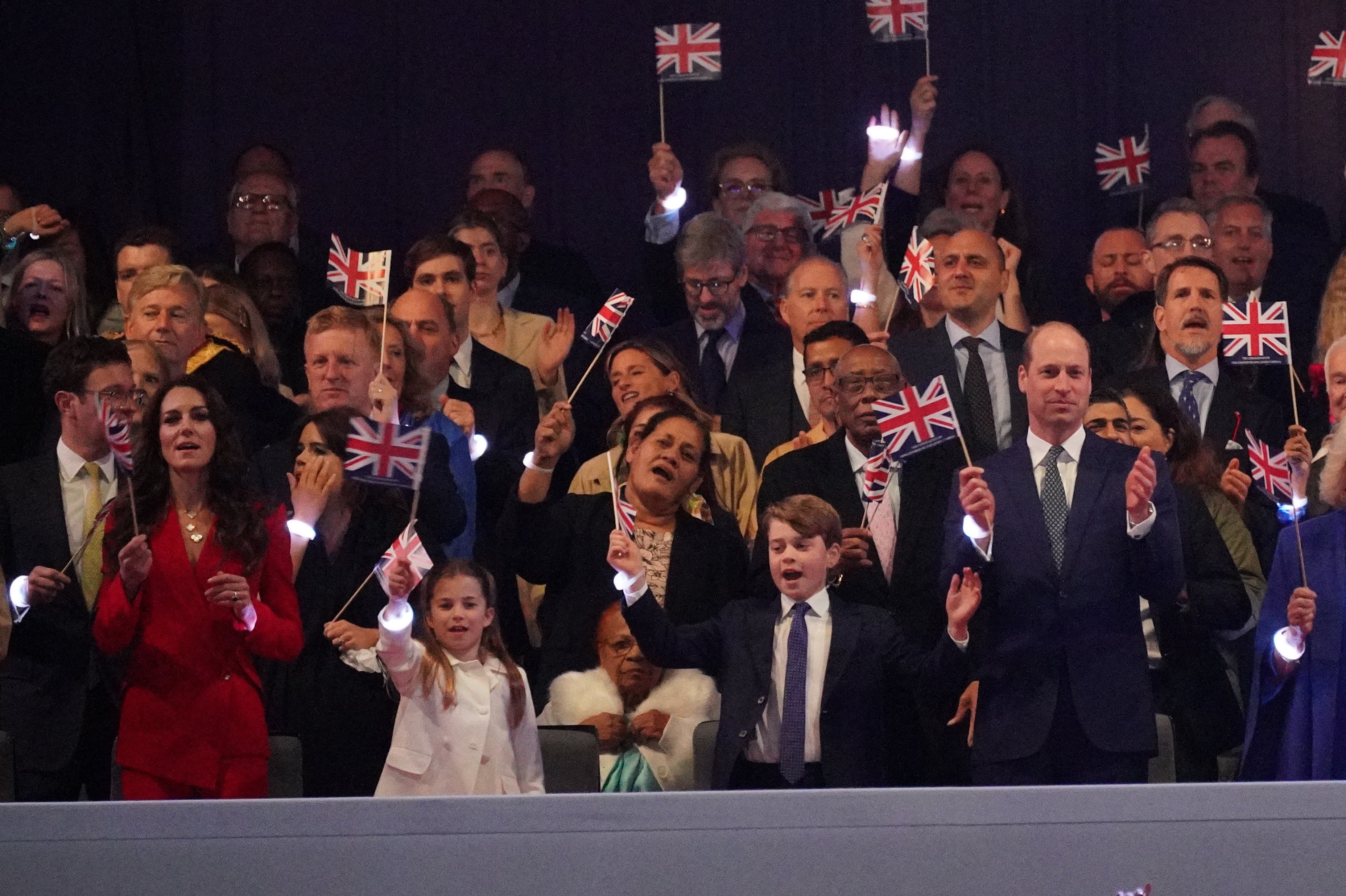 Princess Charlotte can be seen waving her flag and dancing.