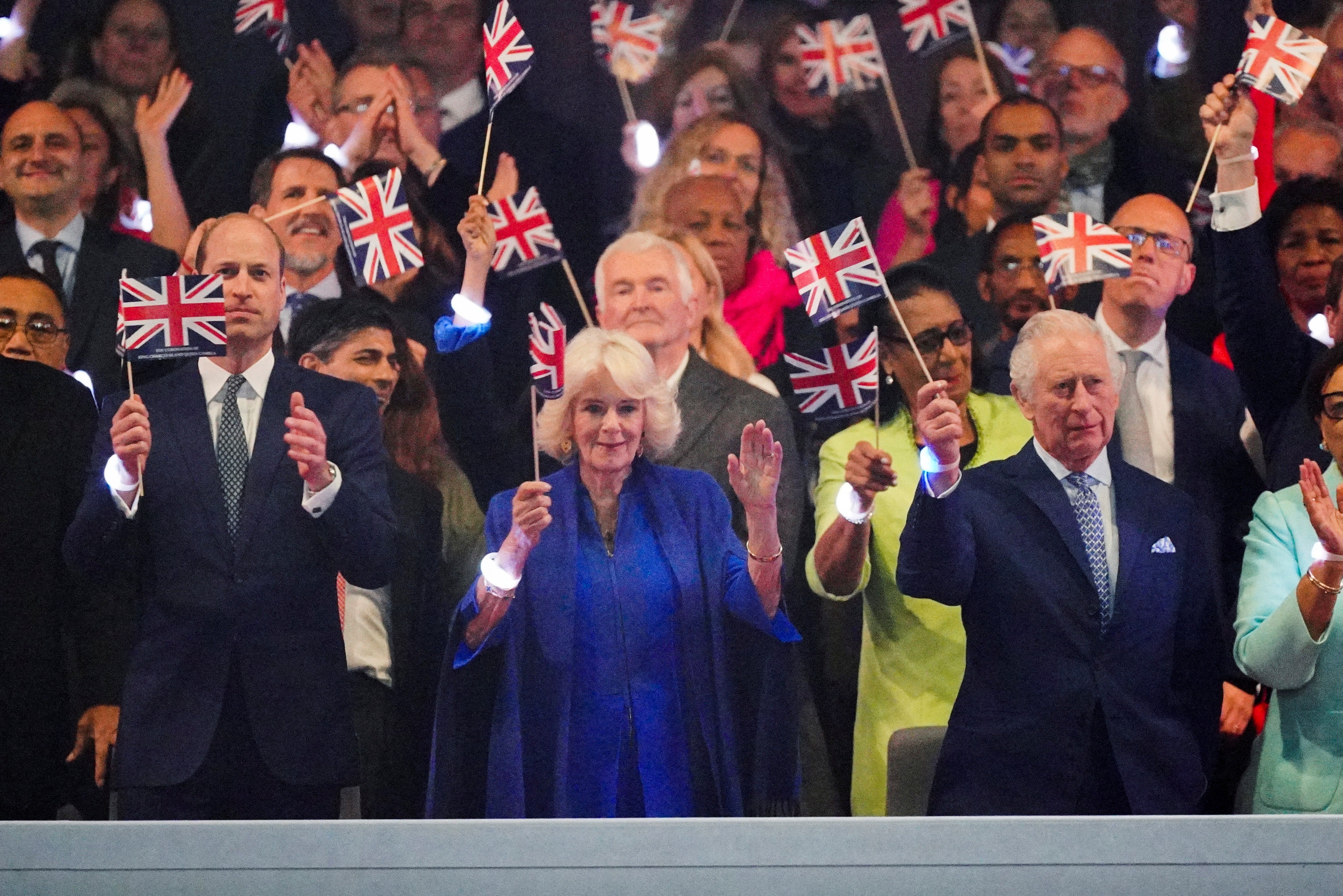 King Charles and Queen Camilla were seen standing, dancing and waving their flags at numerous points throughout the momentous evening.