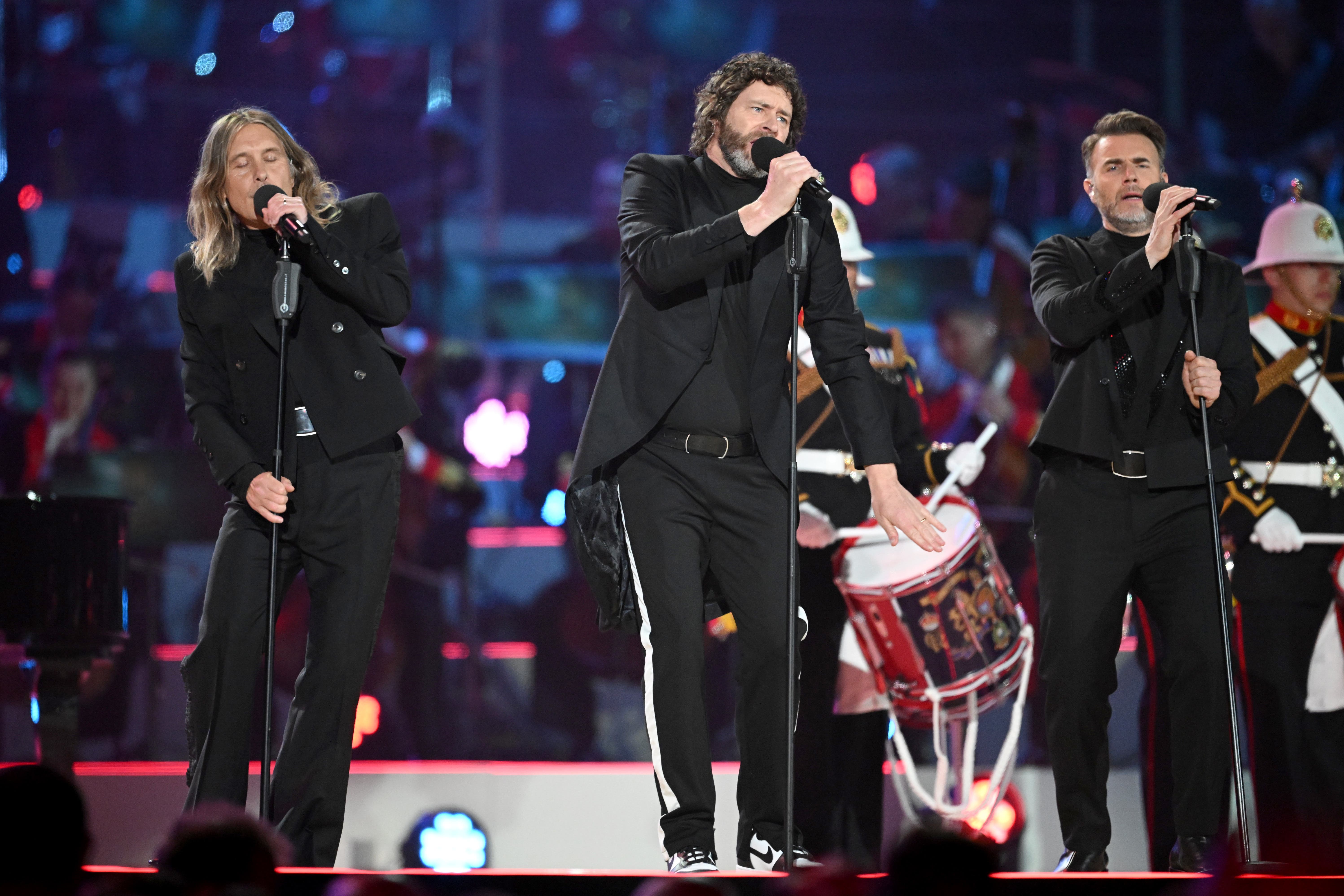 Mark Owen, Howard Donald and Gary Barlow from Take That on stage at the Coronation Concert (PA)