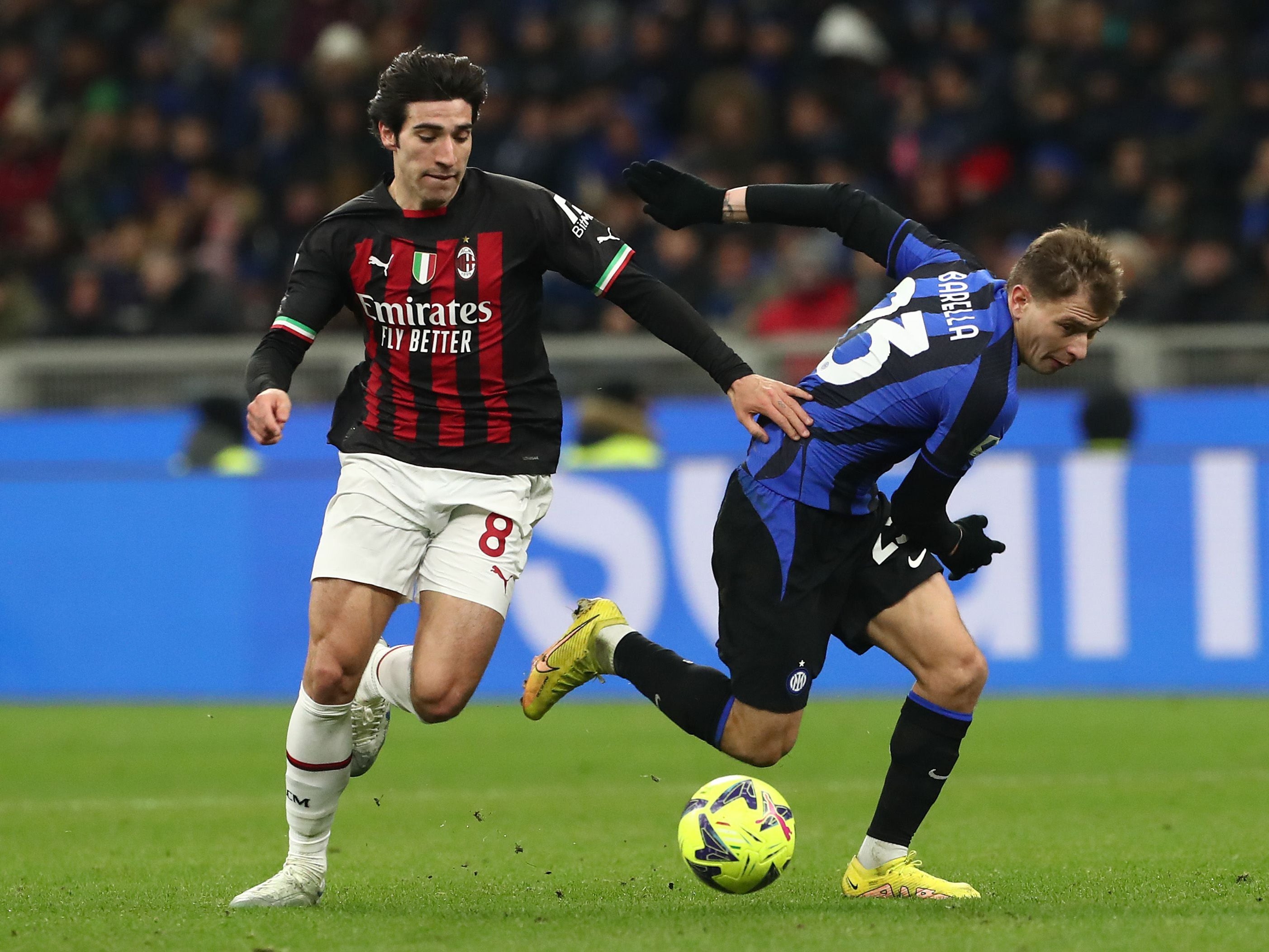 Sandro Tonali battles with Nicolo Barella in the derby