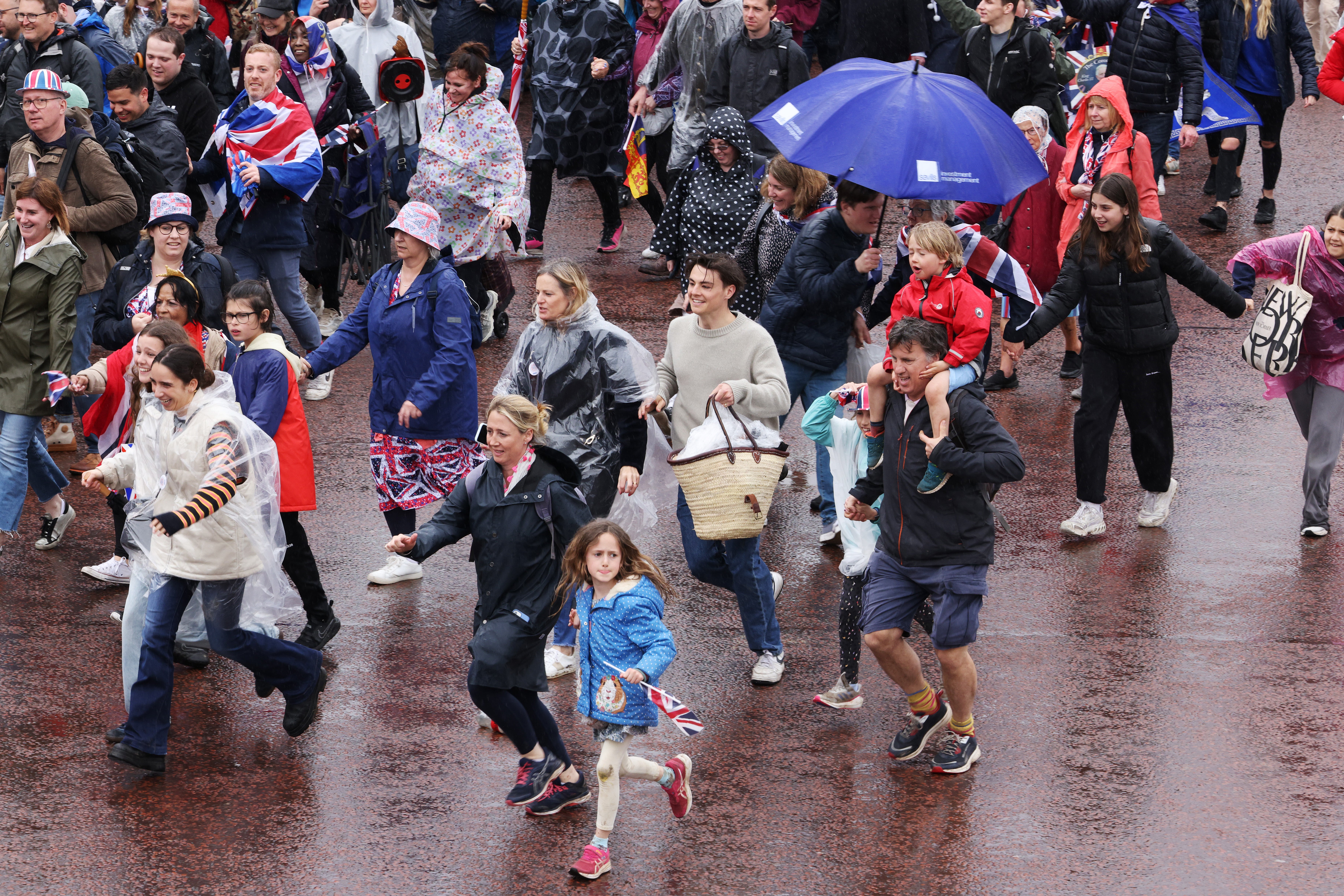 Rain at the coronation left royal fans running for shelter