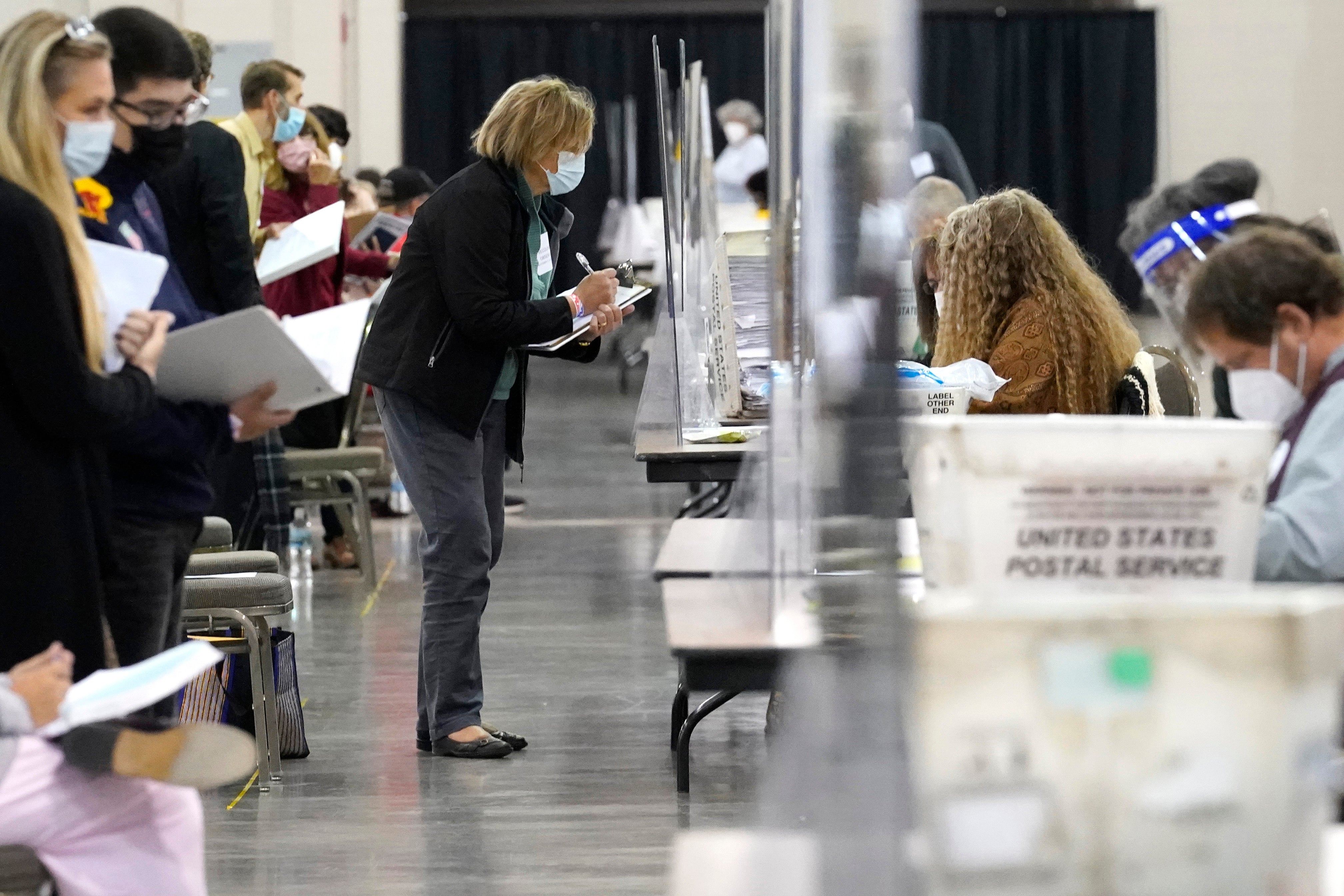 Recount observers watch ballots during a Milwaukee hand recount in November 2020