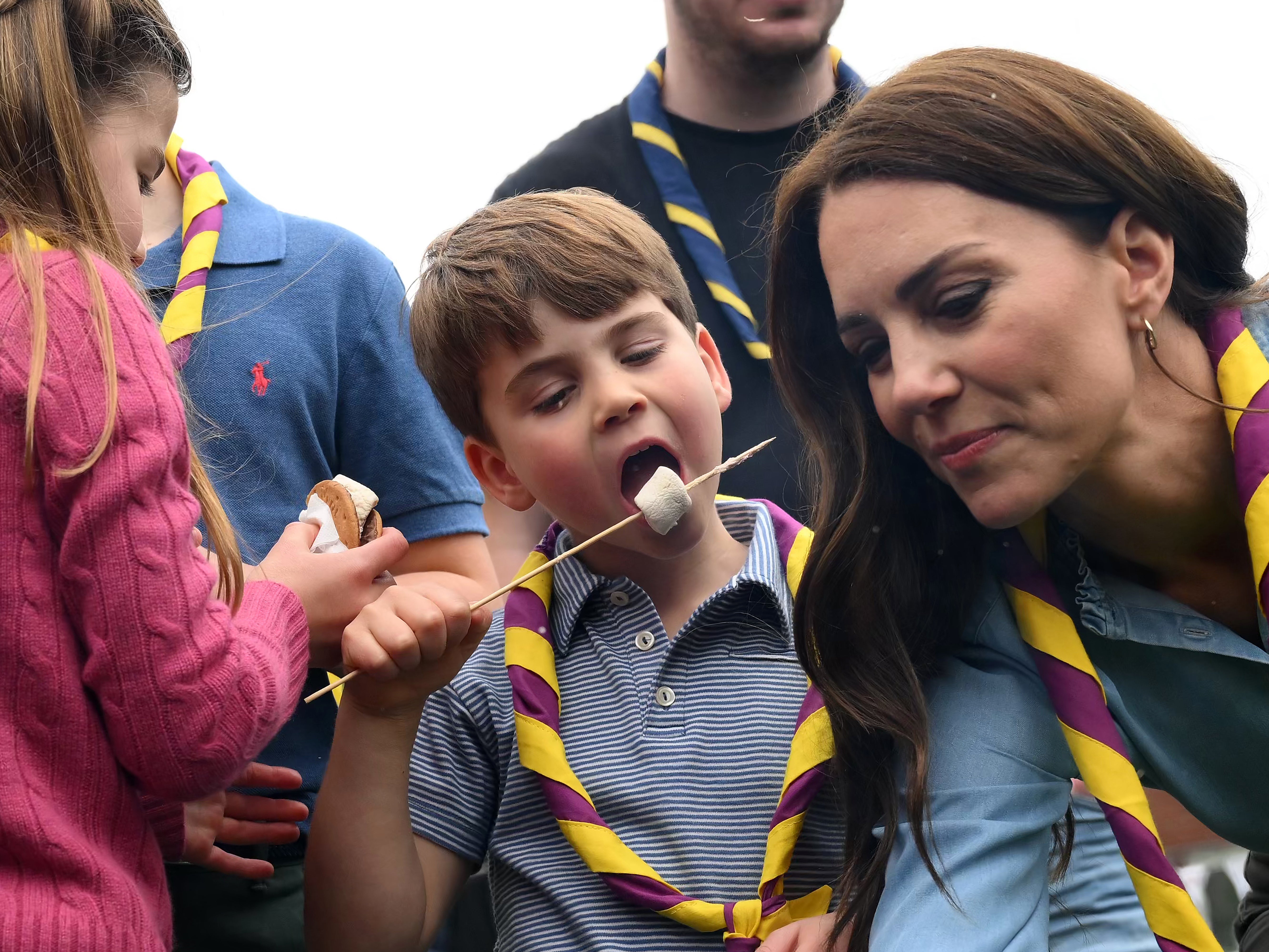 Prince Louis of Wales and his mother Kate toast marshmallows as they take part in the Big Help Out