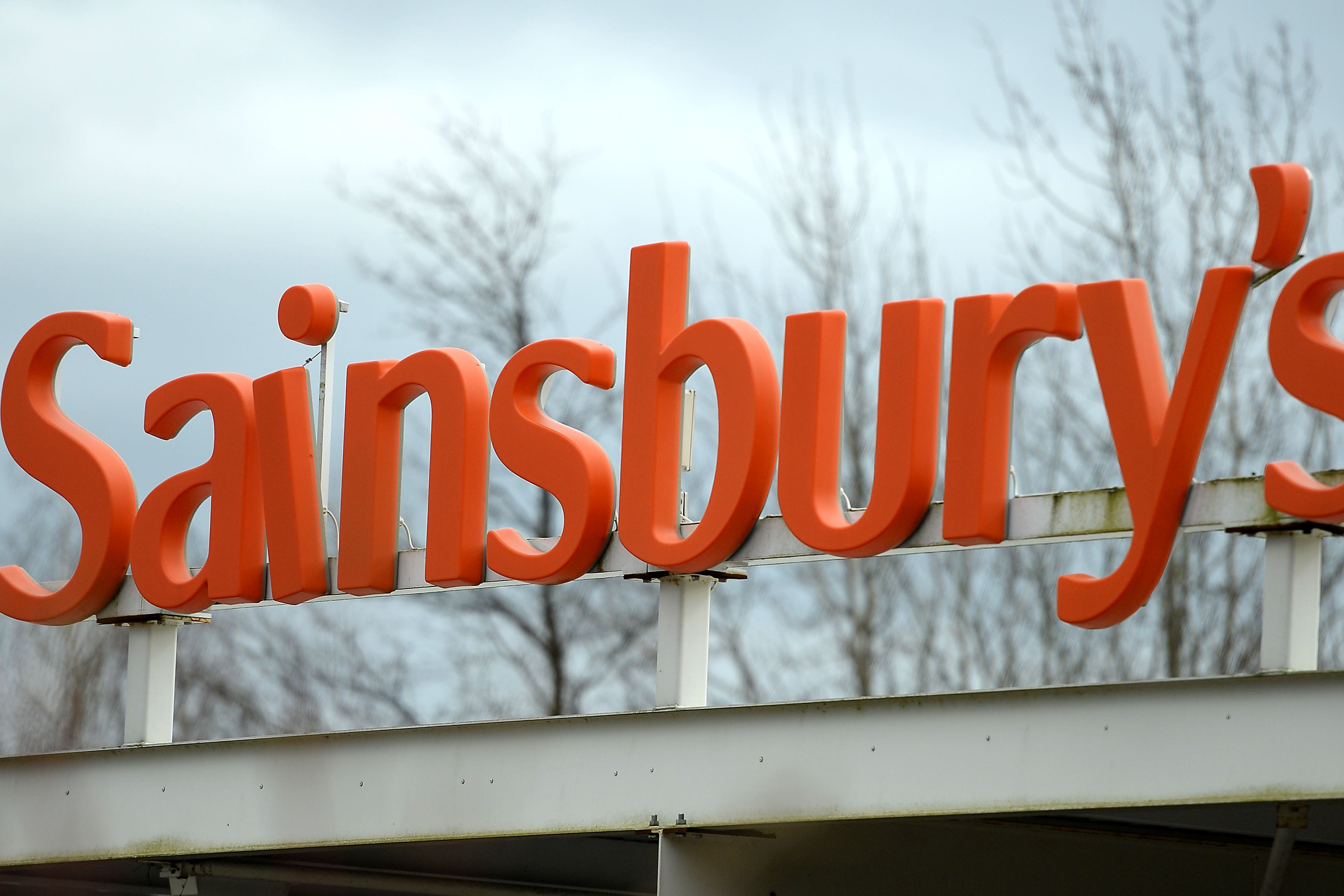 Signage on a Sainsbury’s supermarket (PA)