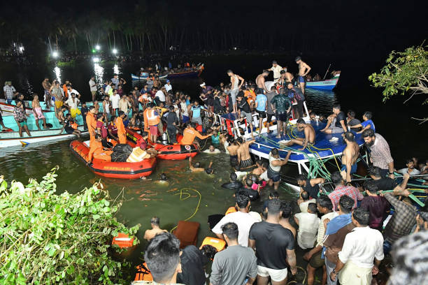 In this photograph taken on 7 May 2023, people carry out rescue operation at the site of a boat accident in Tanur, in Malappuram district of India’s Kerala state