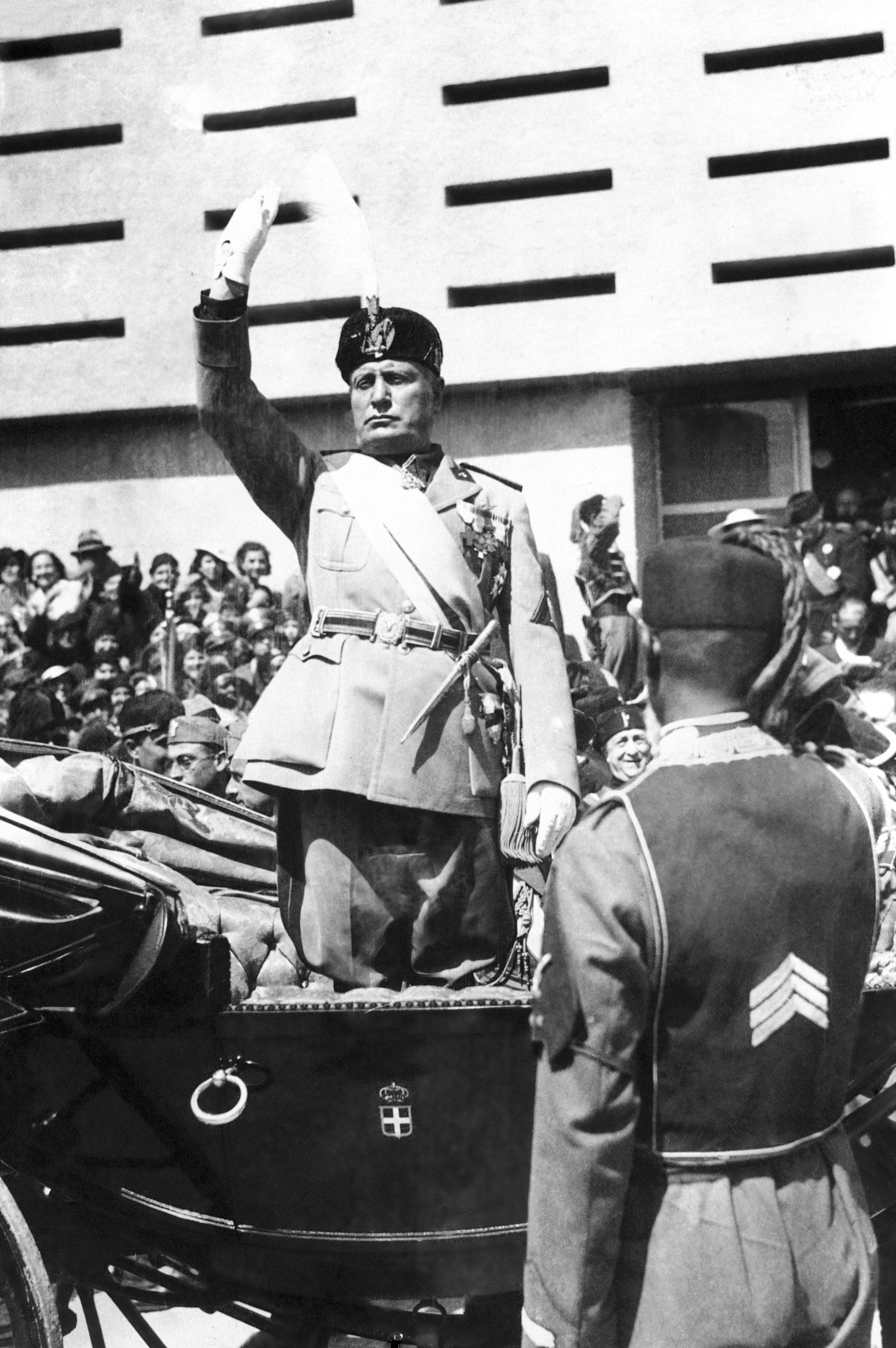 Italian dictator Benito Mussolini gives the Fascist salute