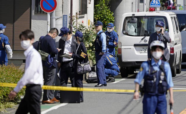 <p>File. Japanese police investigators work near a stabbing scene in Tokyo on 10 May 2023</p>