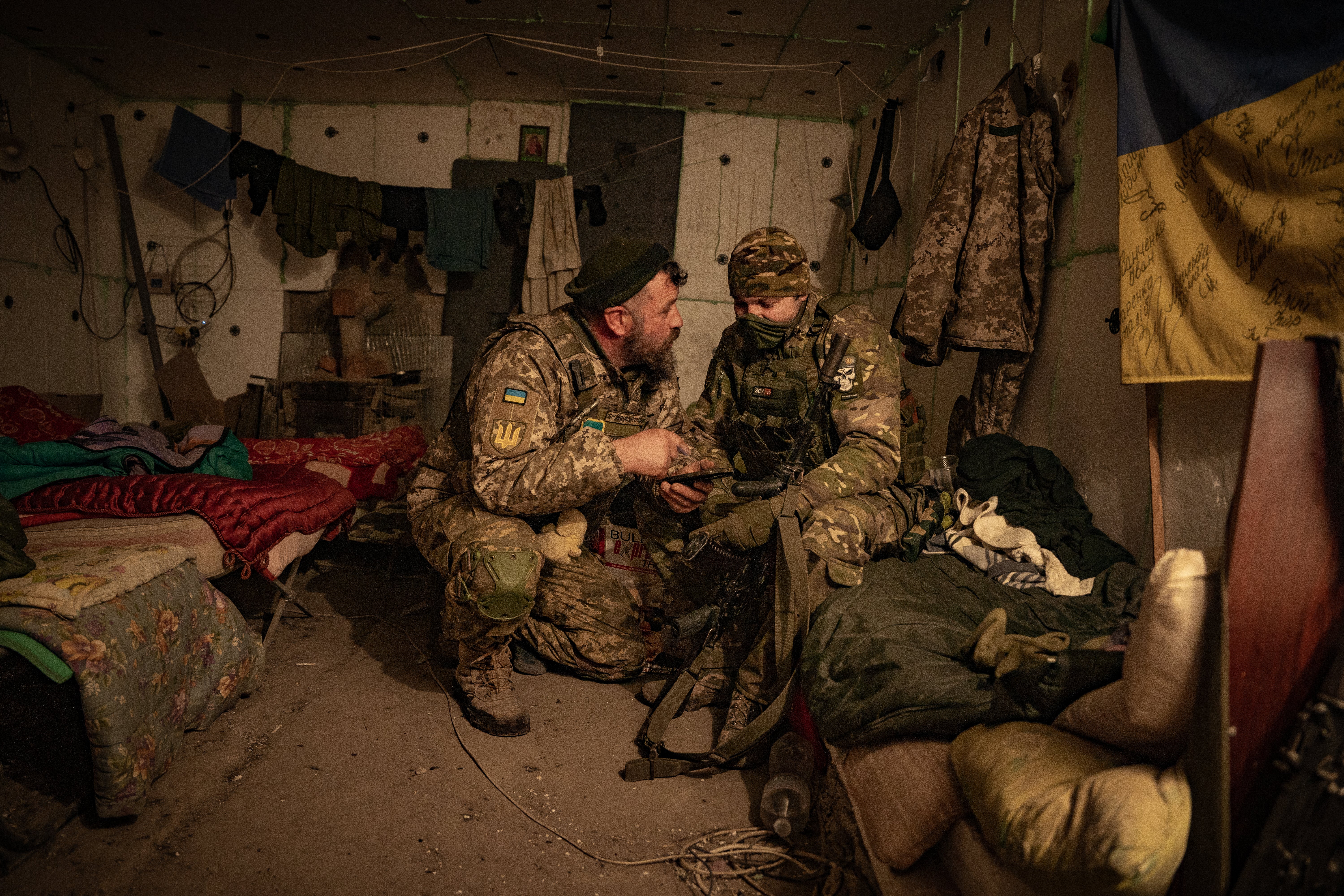 Infantry soldiers discuss an upcoming counteroffensive in a bunker near Orikhiv