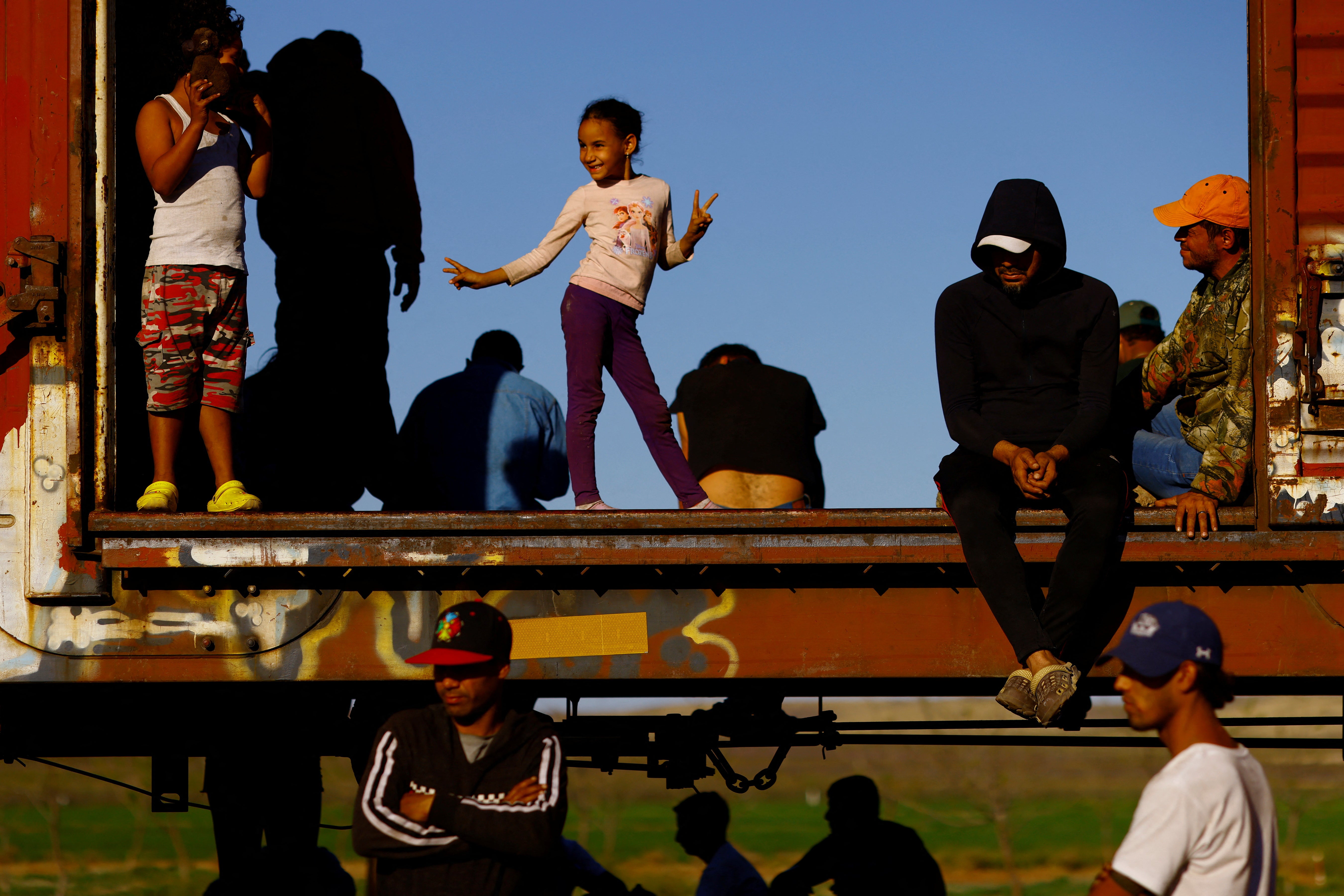 Victoria, a seven-year-old migrant girl, plays inside a carriage as she travels with her family