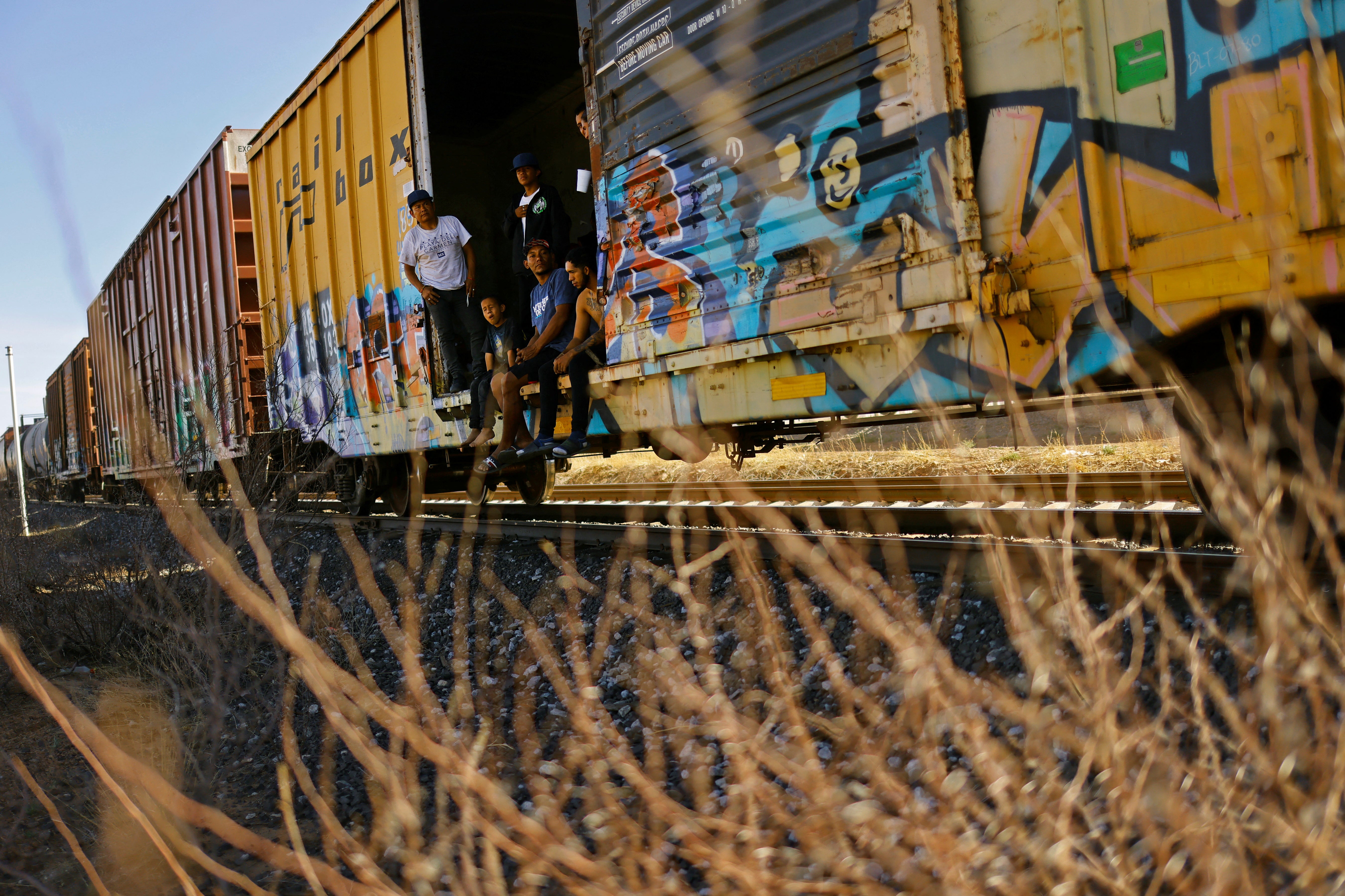 Migrants travel on a train