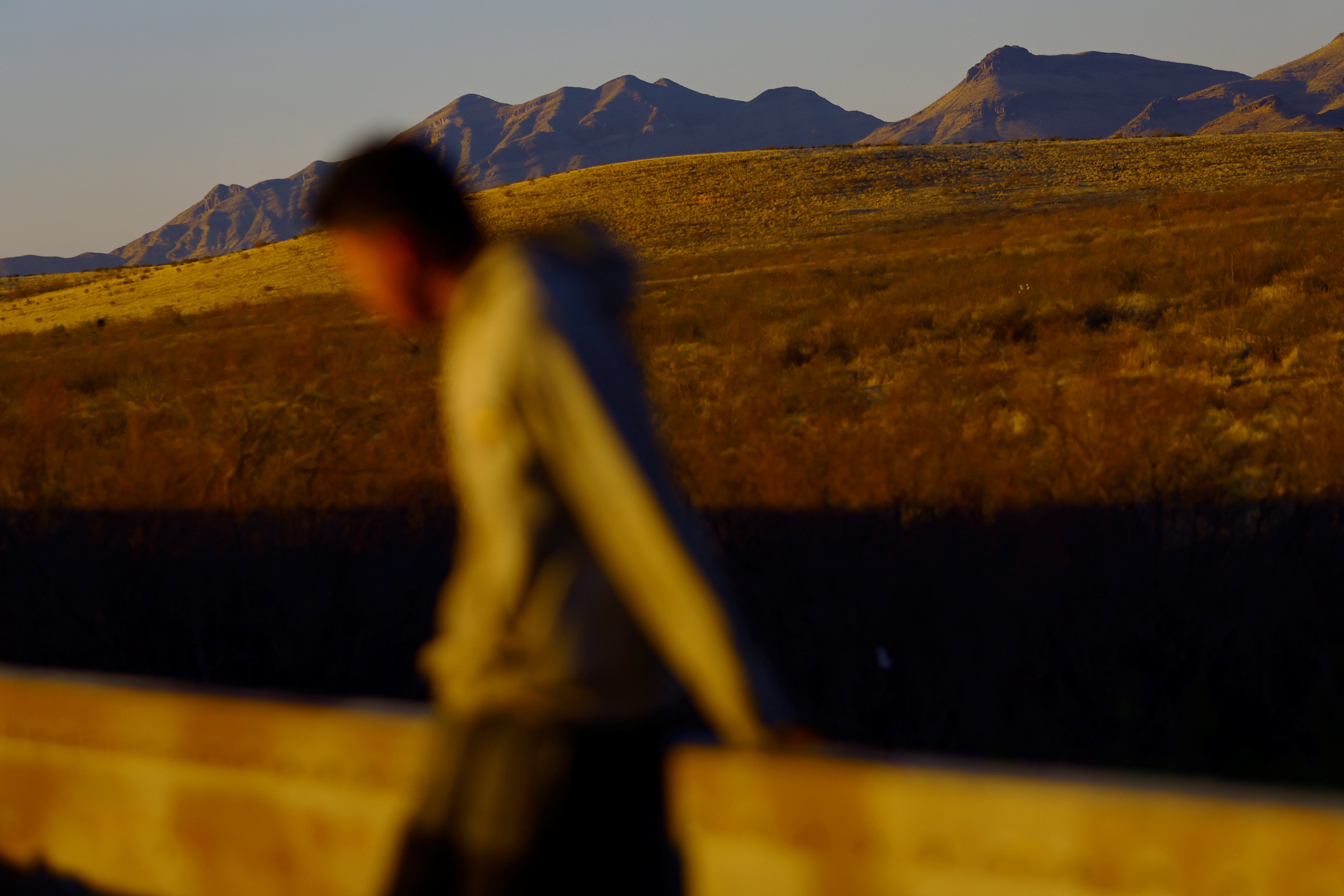 A migrant travels on a train on the outskirts of Ciudad Juarez