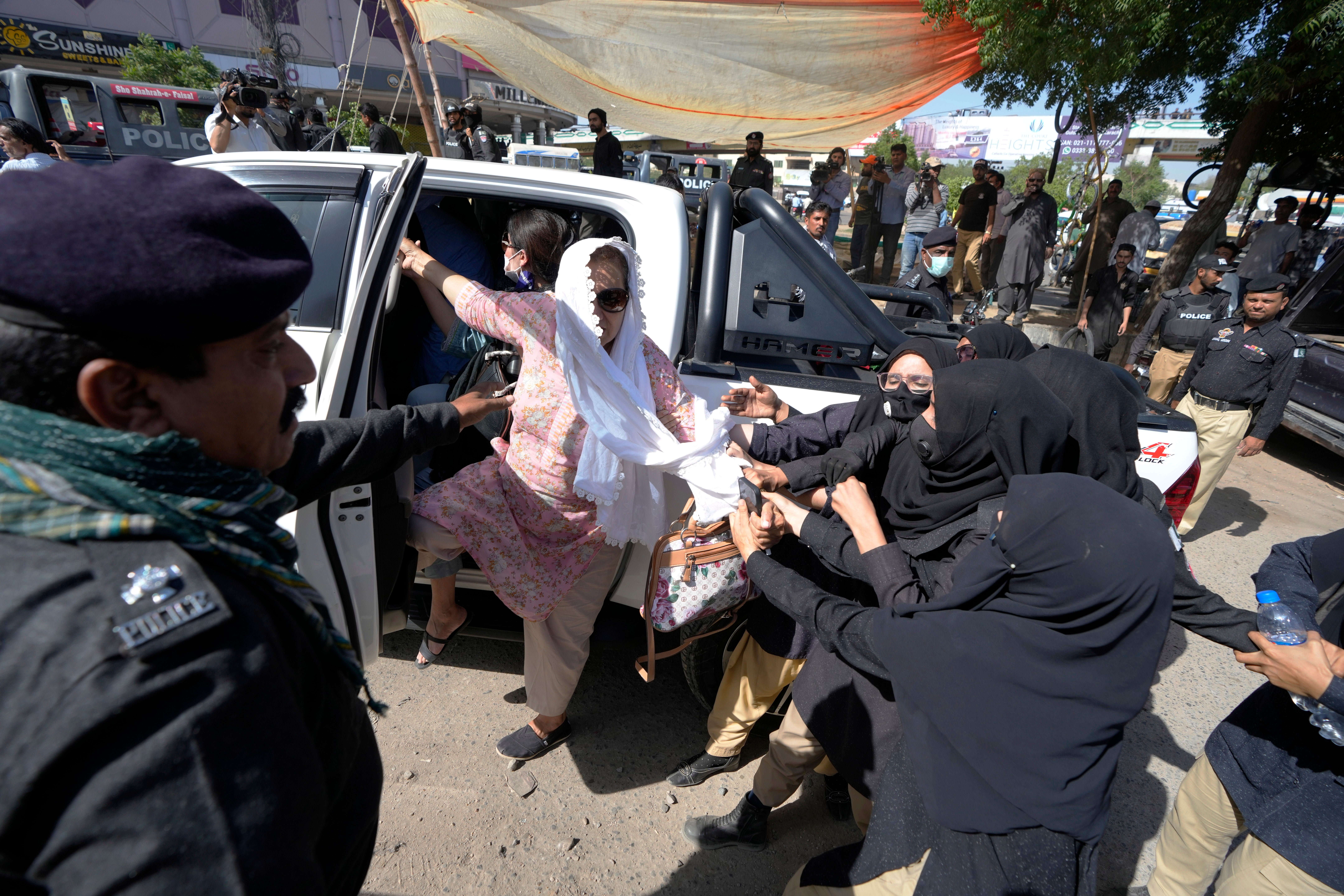 Police detain a supporter of Imran Khan who along with others are protesting against the arrest of their leader, in Karachi, Pakistan, Wednesday, 10 May 2023