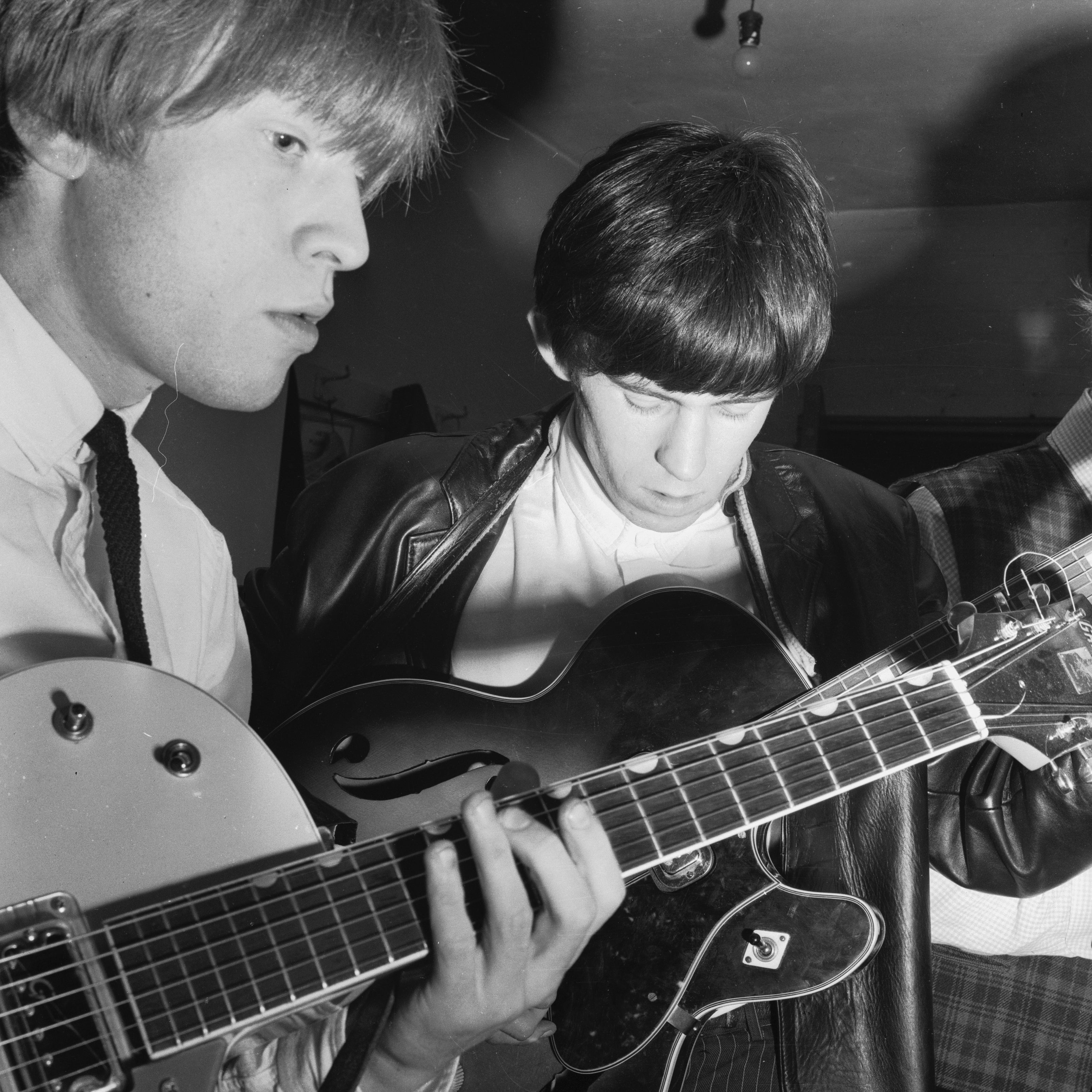 Richards (right) and Jones playing guitar in 1963