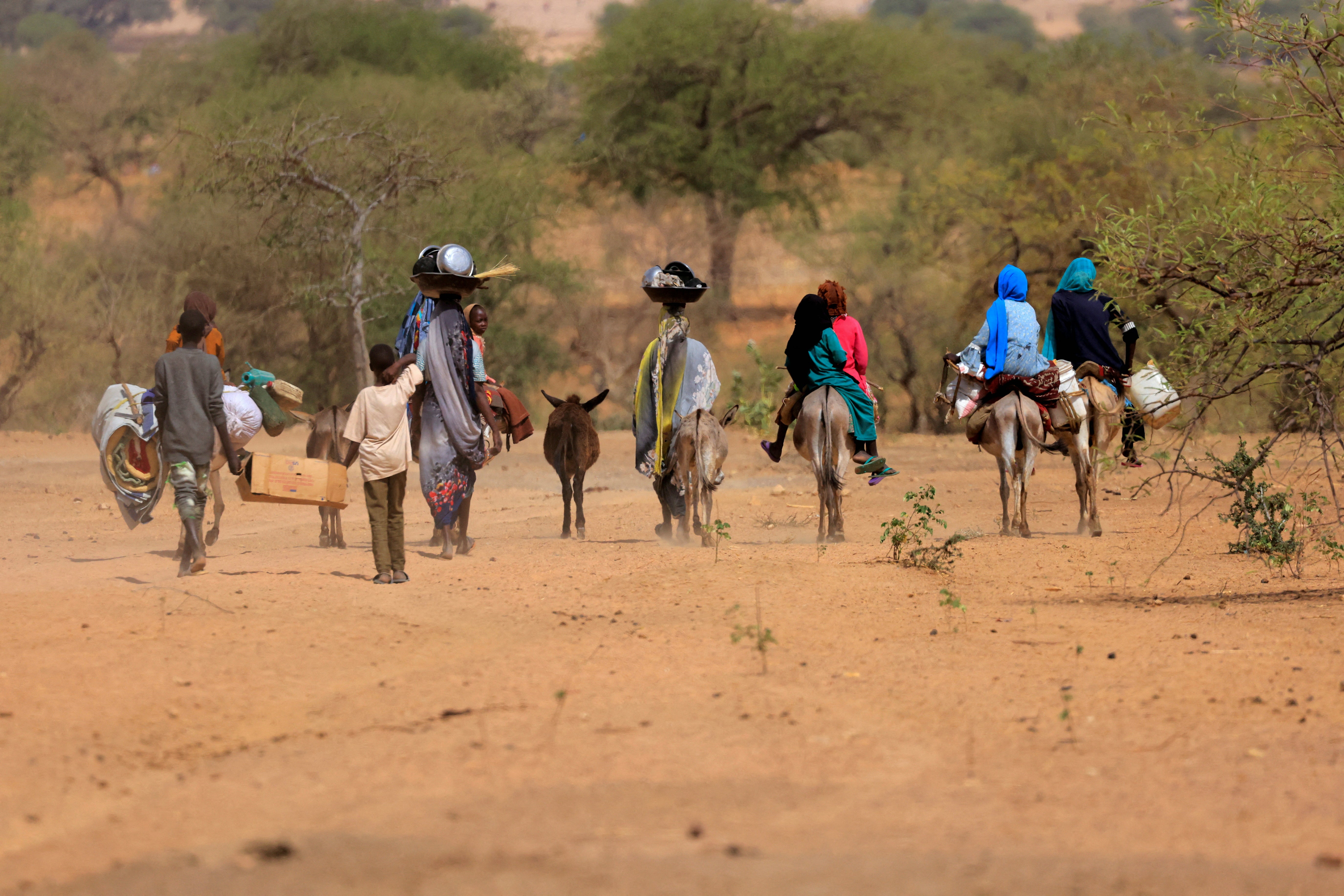 Sudanese families fleeing the conflict, which broke out on 15 April and has left many others trapped