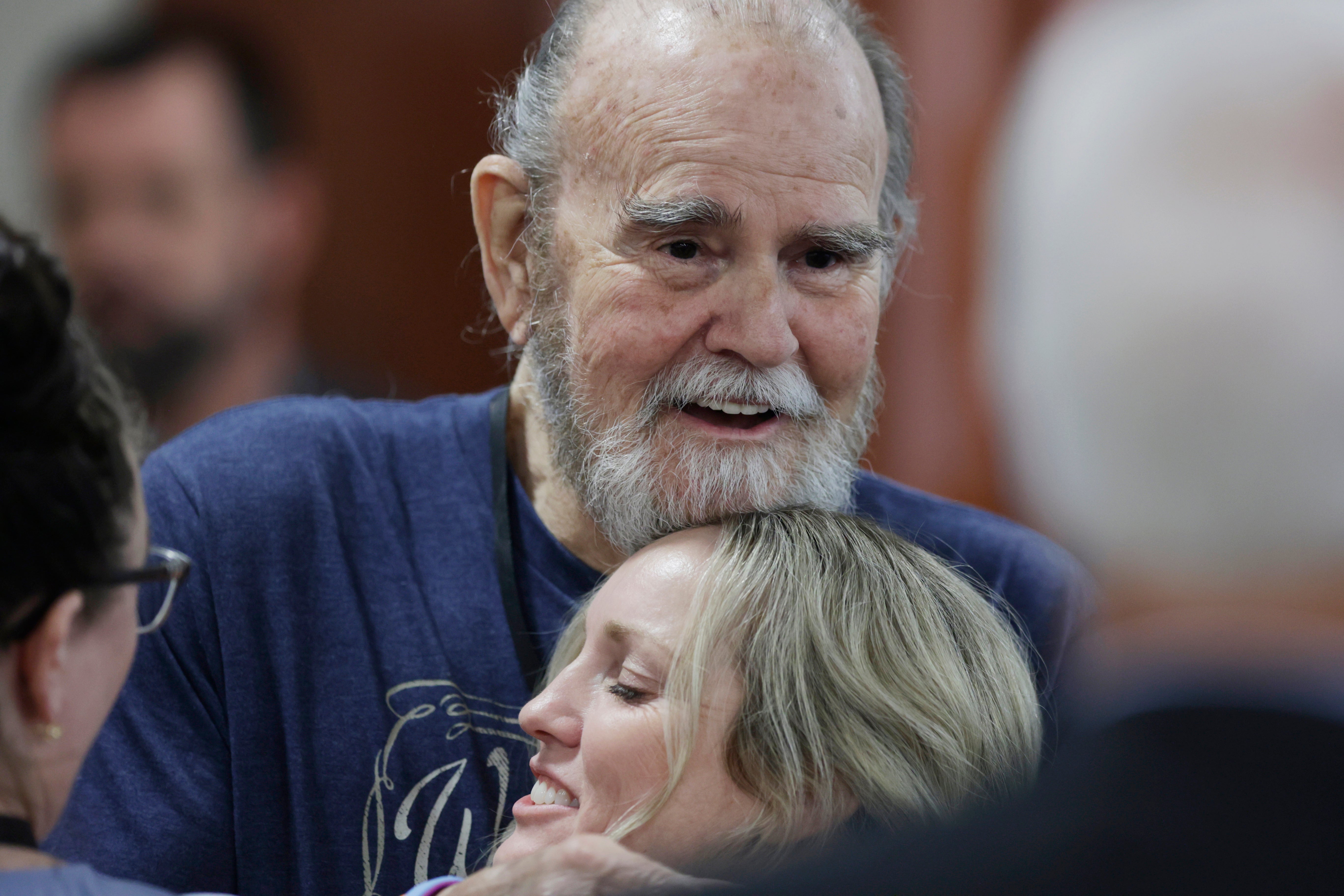 Larry Woodcock hugs an attendee after the verdict was read