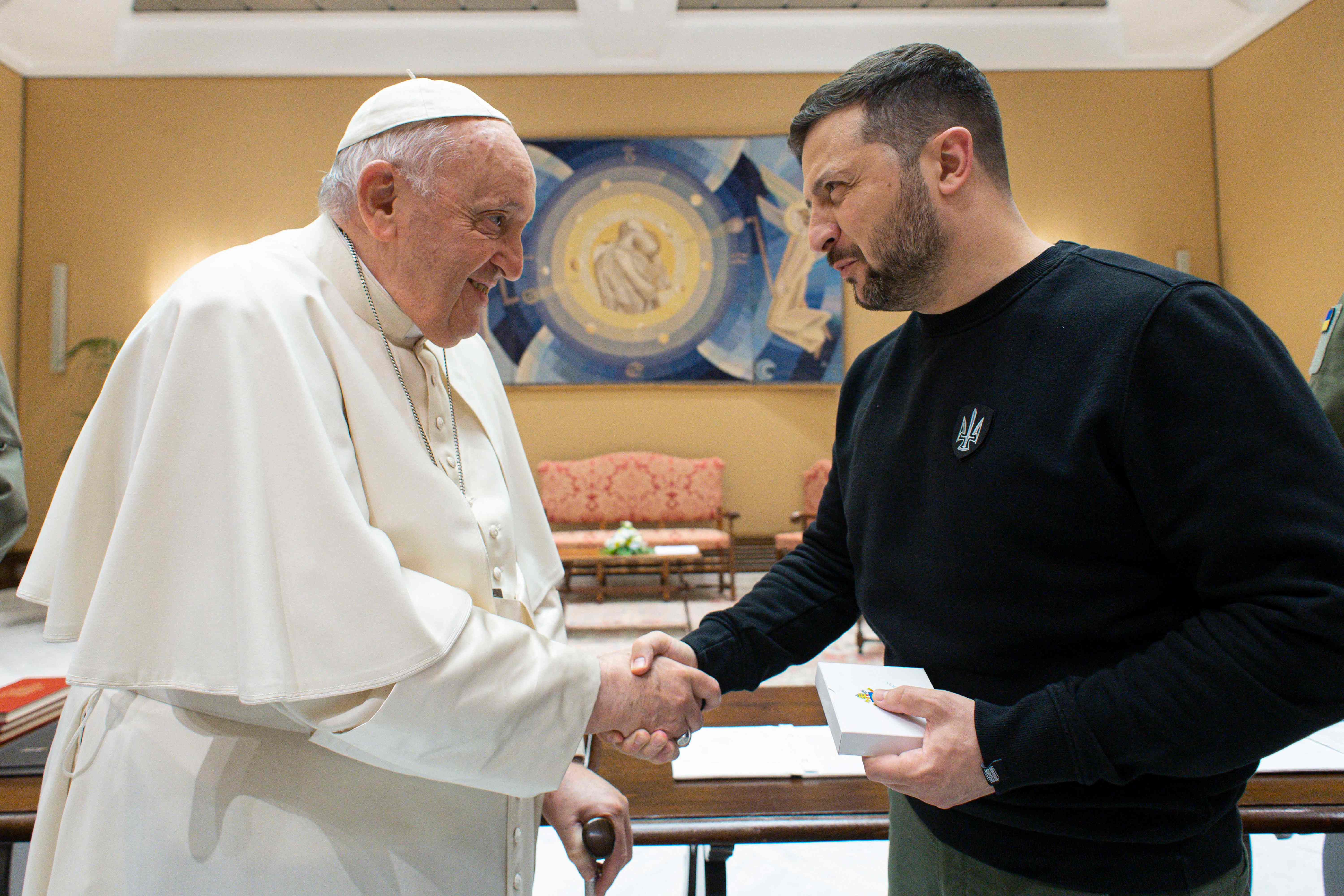 Pope Francis and Zelensky shake hands following a private audience in the Vatican