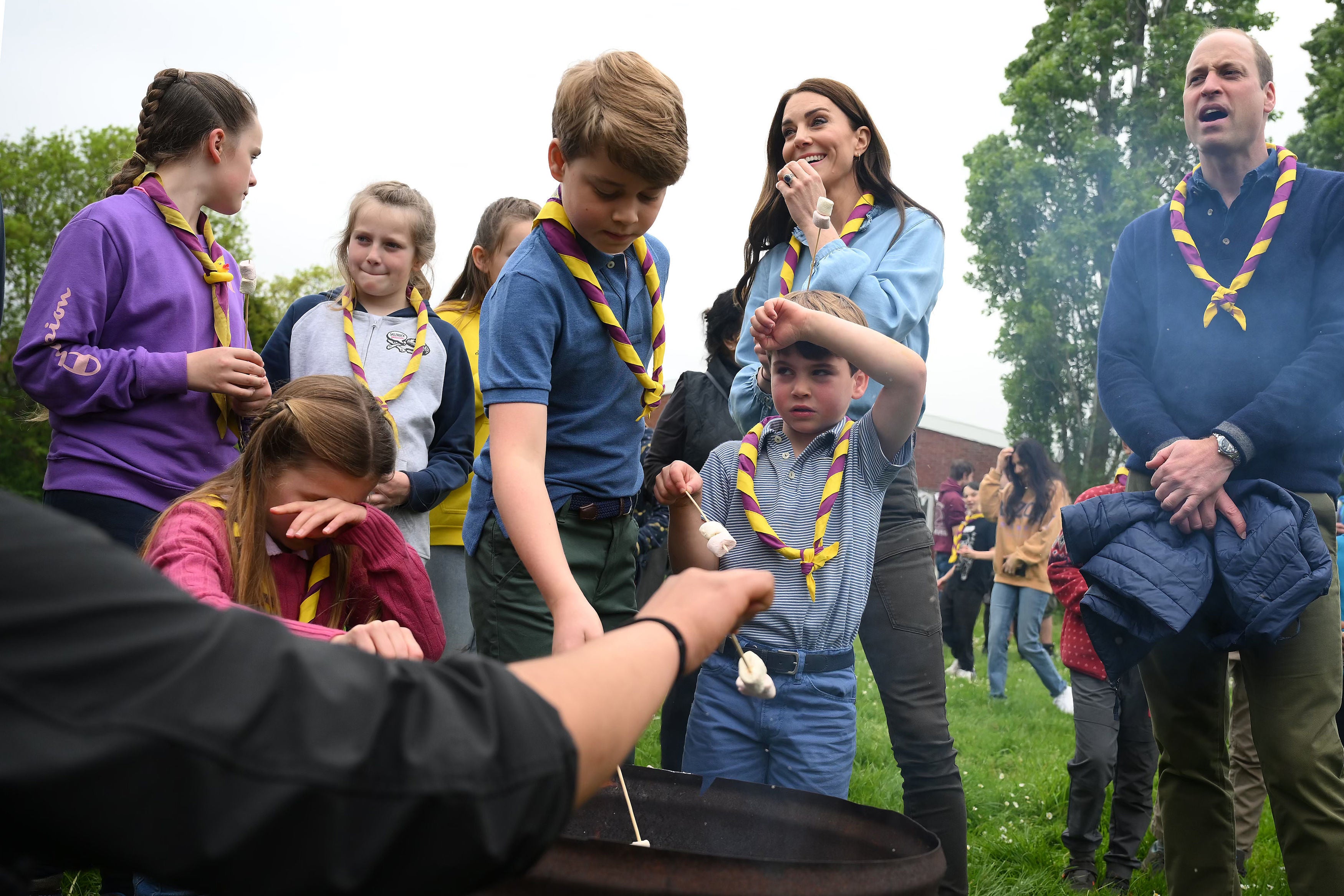 Princess Charlotte, Prince George, Prince Louis, the Princess of Wales and the Prince of Wales toast marshmallows as they join volunteers to help renovate and improve the 3rd Upton Scouts Hut in Slough last Monday