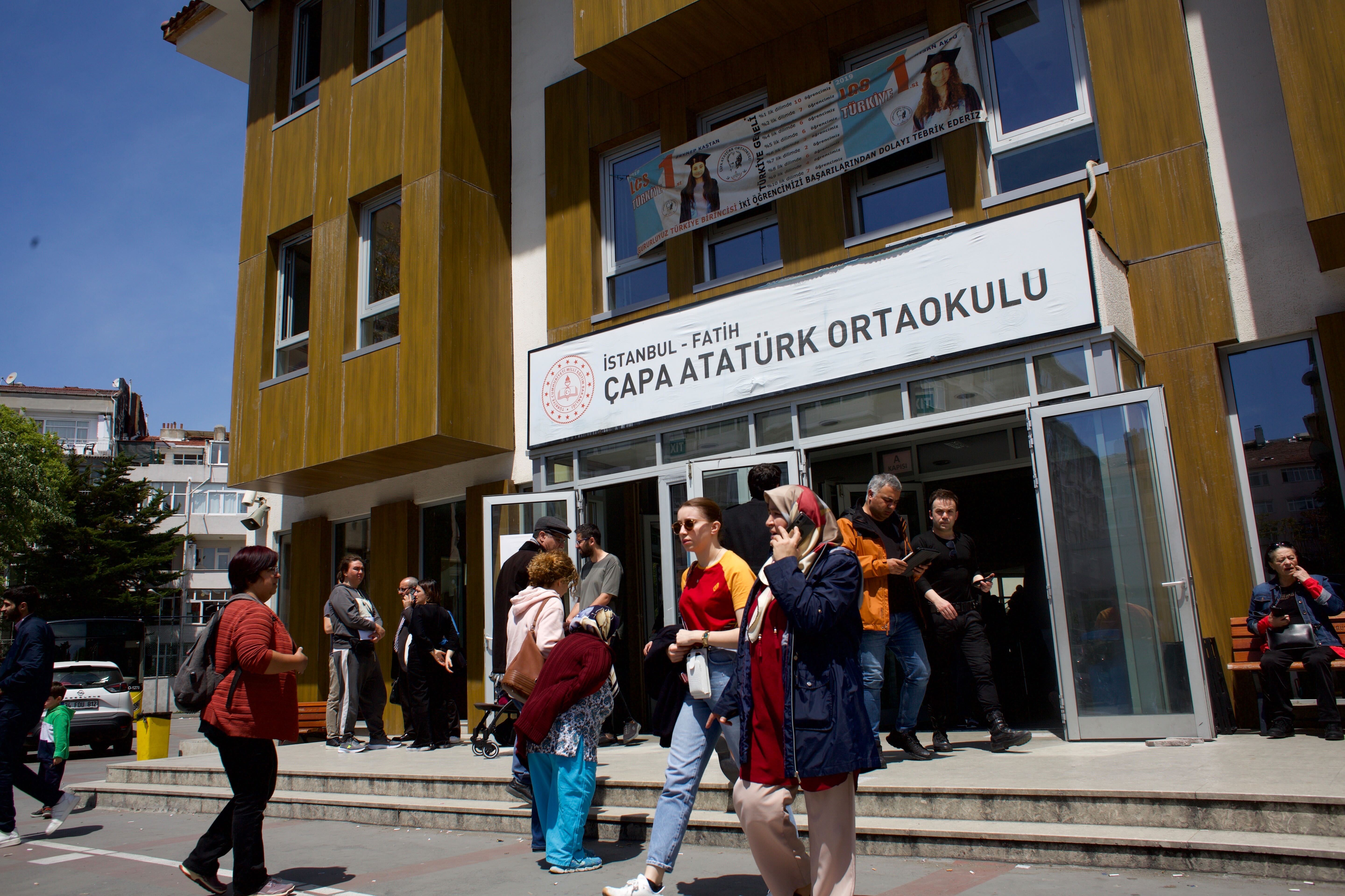 Voters emerge from a balloting station in the Istanbul district of Fatih