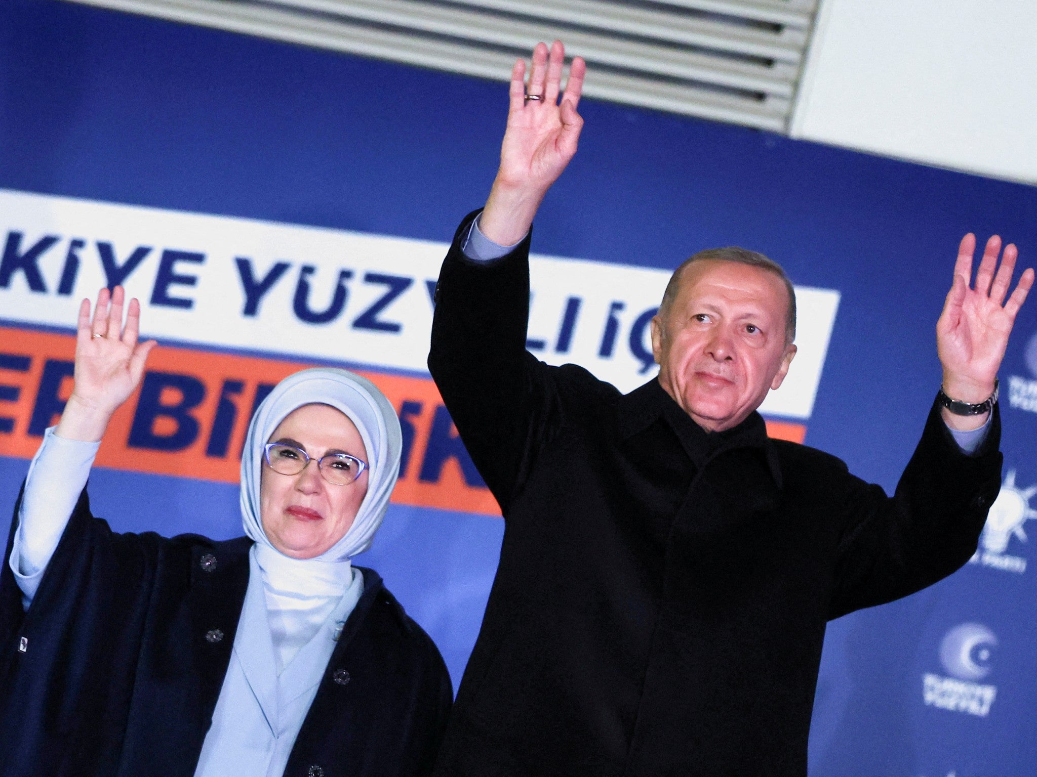 Recep Tayyip Erdogan, accompanied by his wife Ermine Erdogan, greets supporters in Ankara