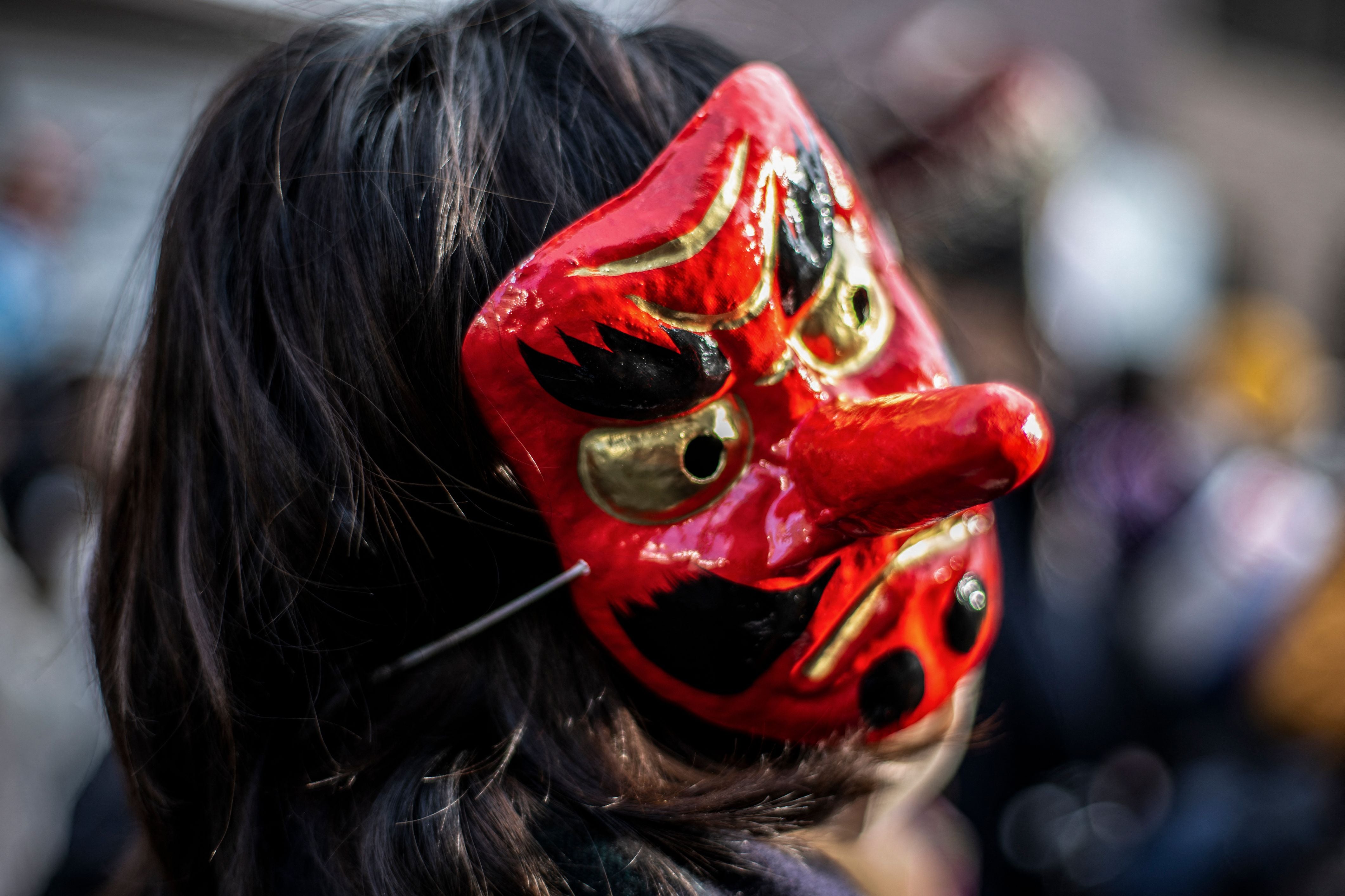 A woman wearing a Tengu mask takes part in the Tengu Parade, a traditional event held to drive away evil spirits and to bring good luck