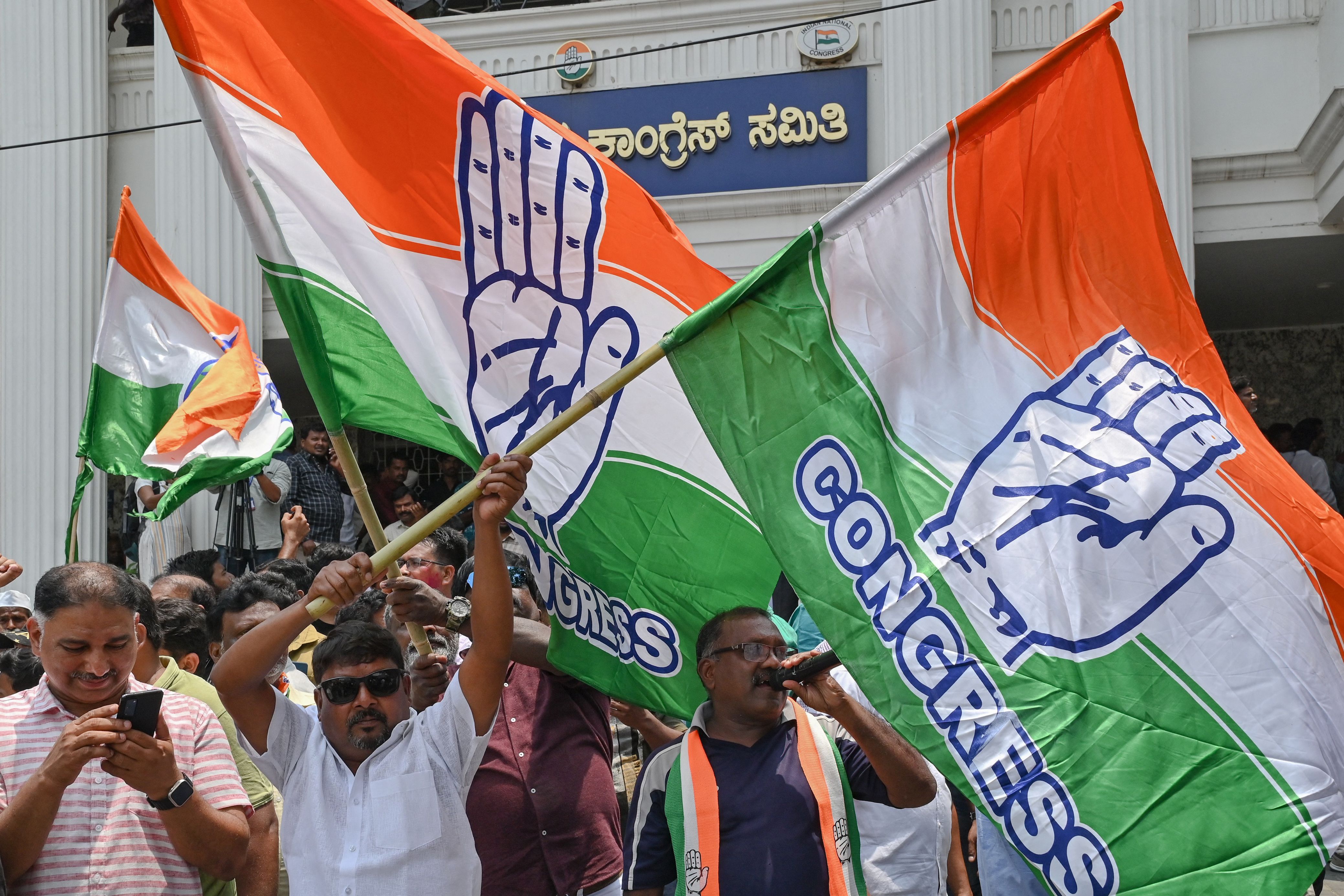 Congress workers burst into celebration after the party’s win in Karnataka