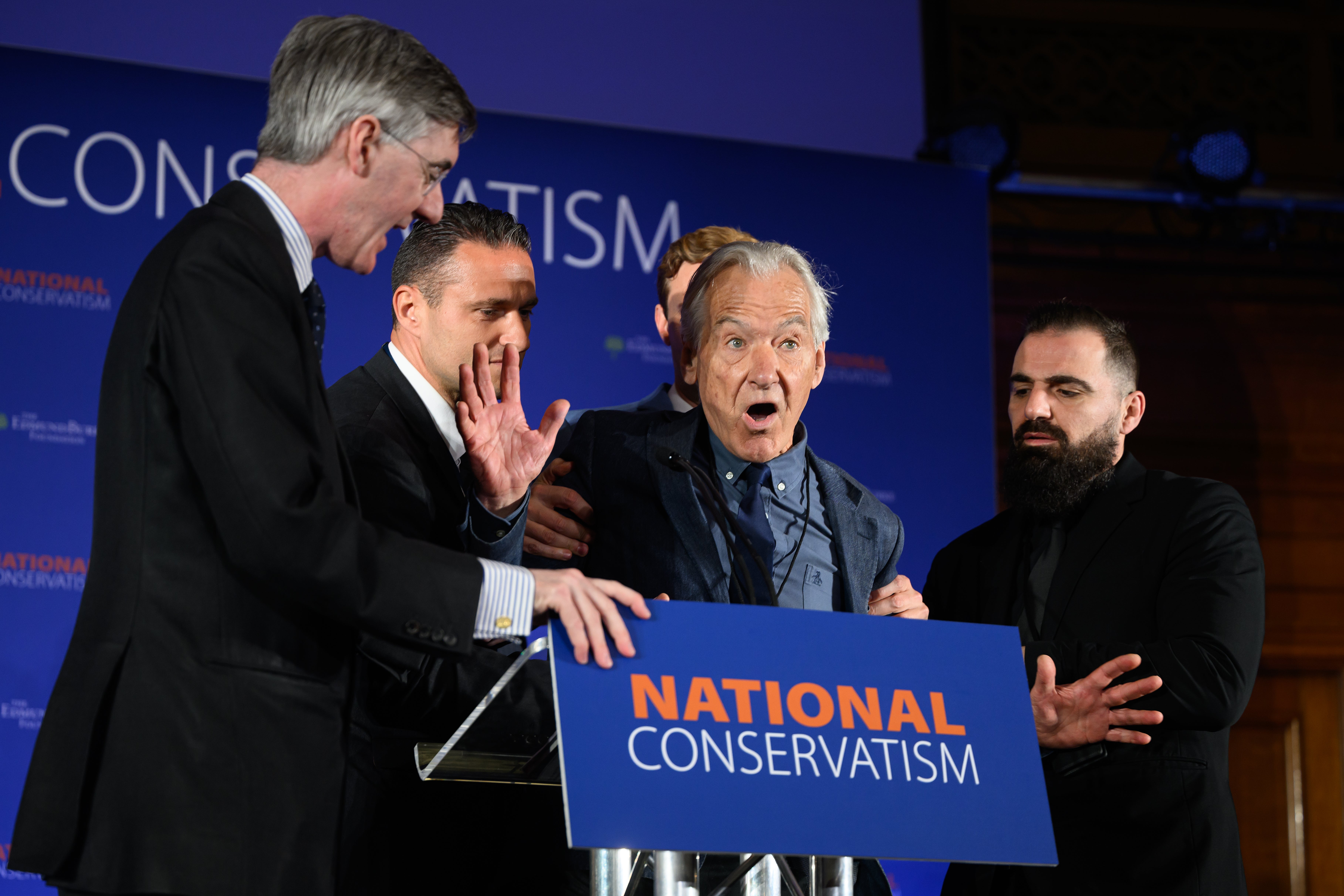 A heckler is dragged away after interrupting Jacob Rees-Mogg at the National Conservatism conference in London on Monday