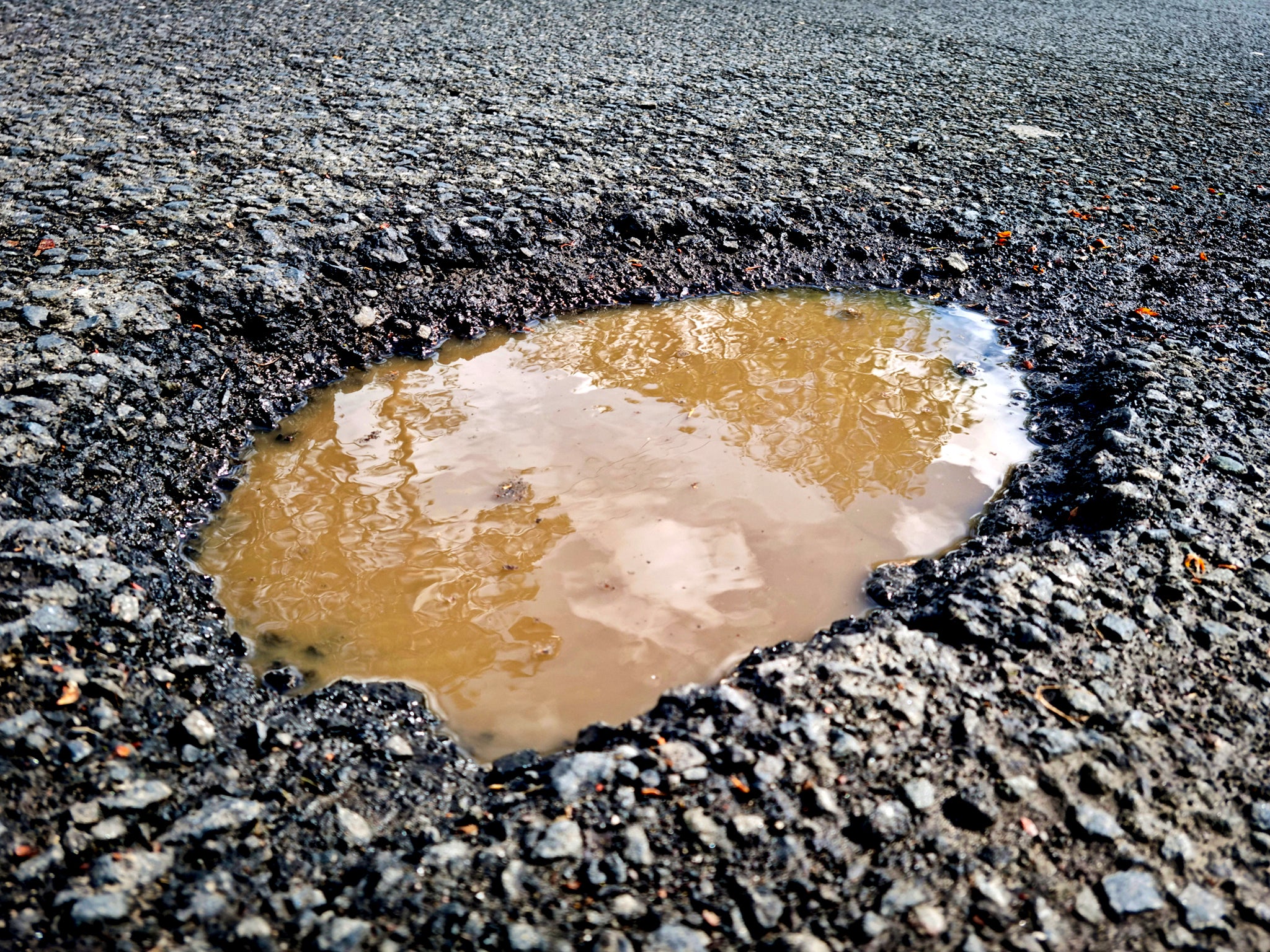 File photo: A pothole filled with rainwater