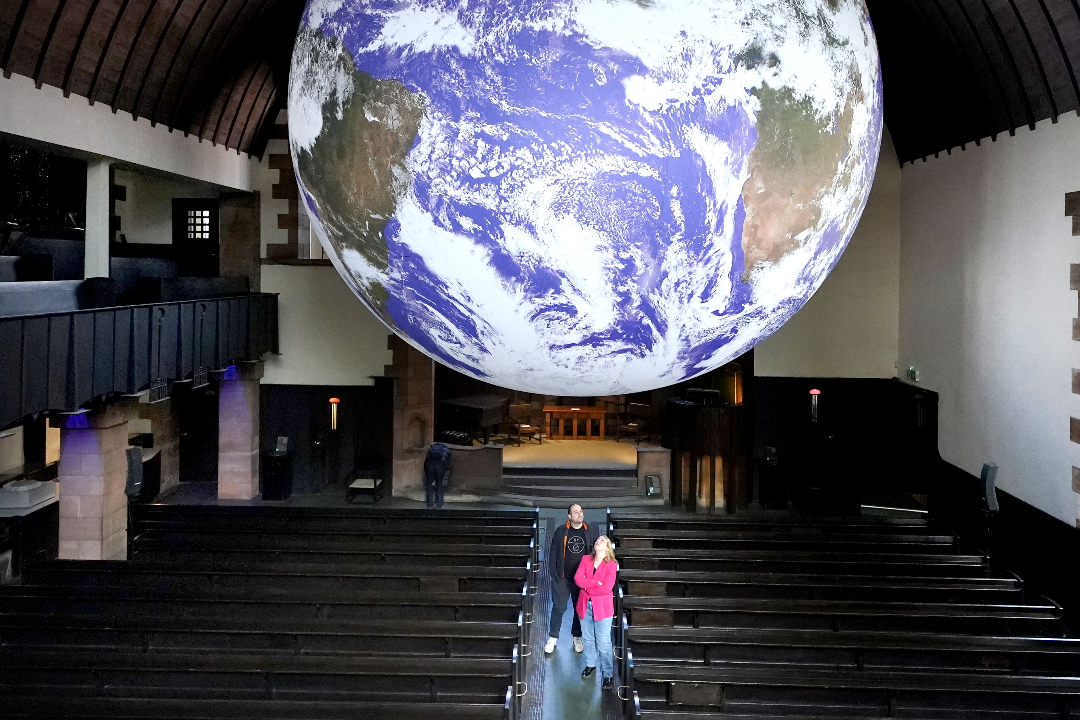 A visitor’s view of Gaia, a seven-metre-wide replica of Earth created by Luke Jerram.