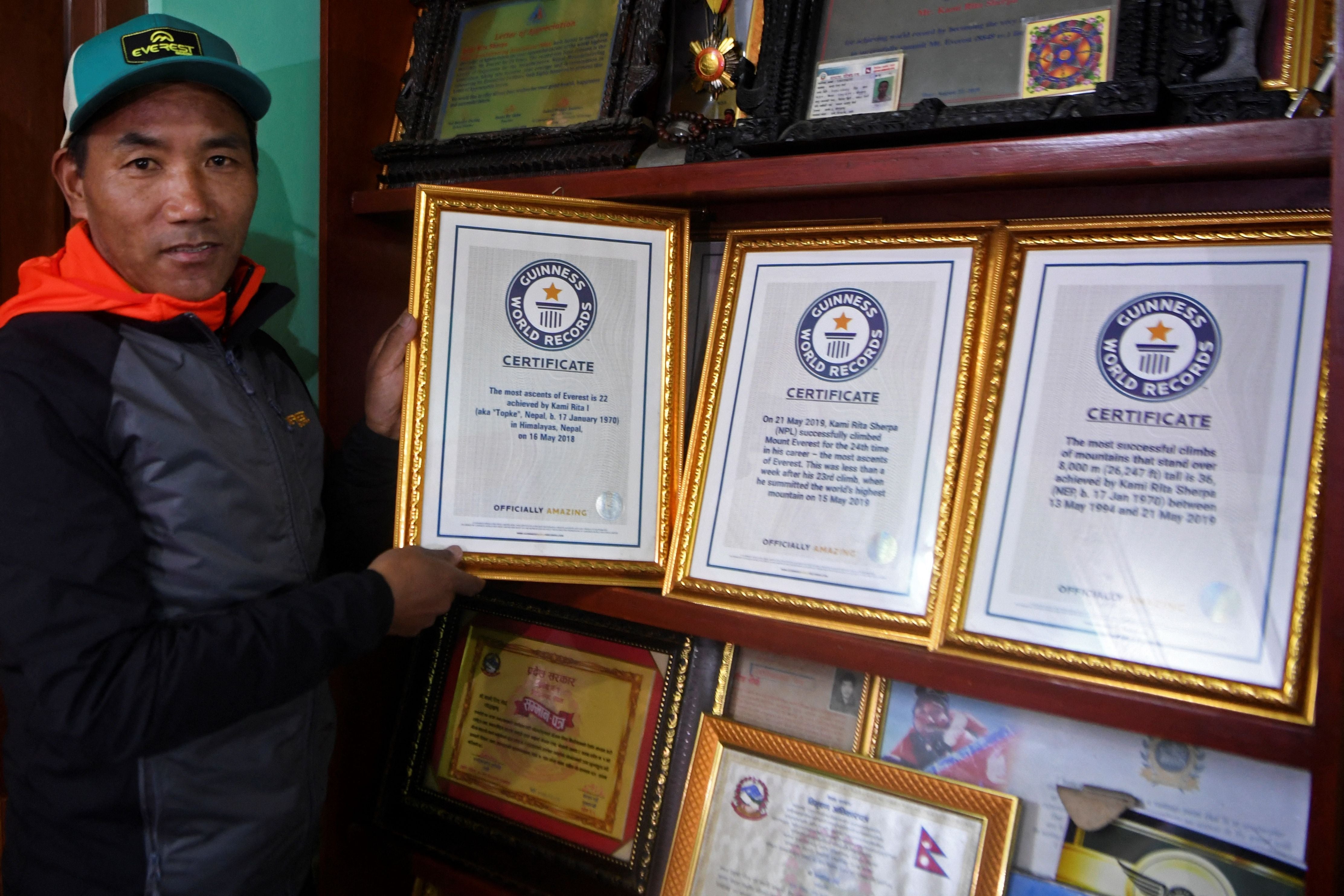 Nepal’s mountaineer Kami Rita Sherpa poses with his Guinness World Record certificates