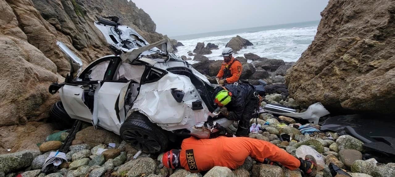 Emergency personnel respond to a vehicle over the side of Highway 1