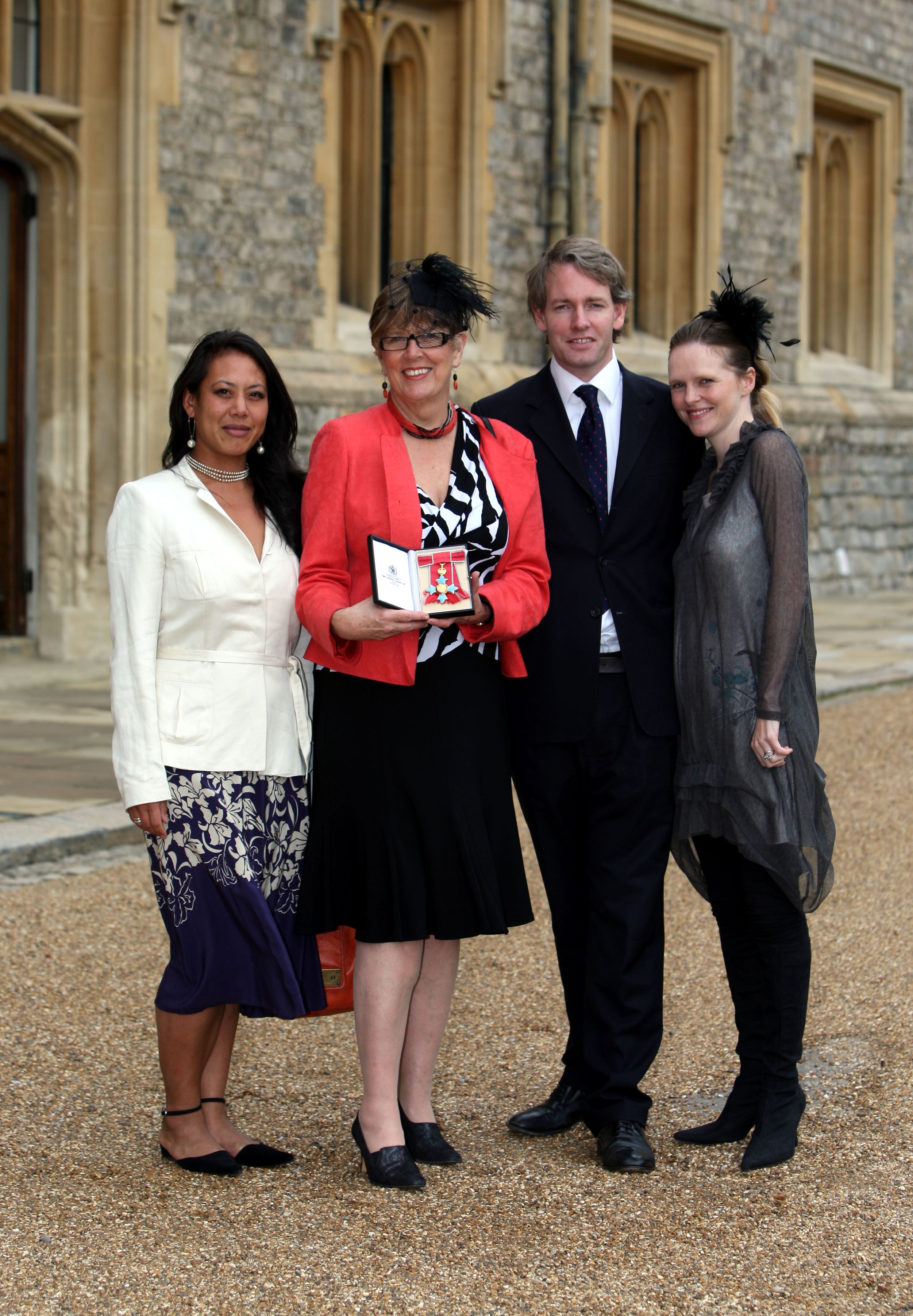 Prue Leith (2nd-L), with daughter Li-Da Kruger (L), her son Danny Kruger and his wife Emma pose after she became a Commander of the British Empire (CBE) by the Princess Royal during the investiture ceremony at Windsor Castle on October 5, 2010