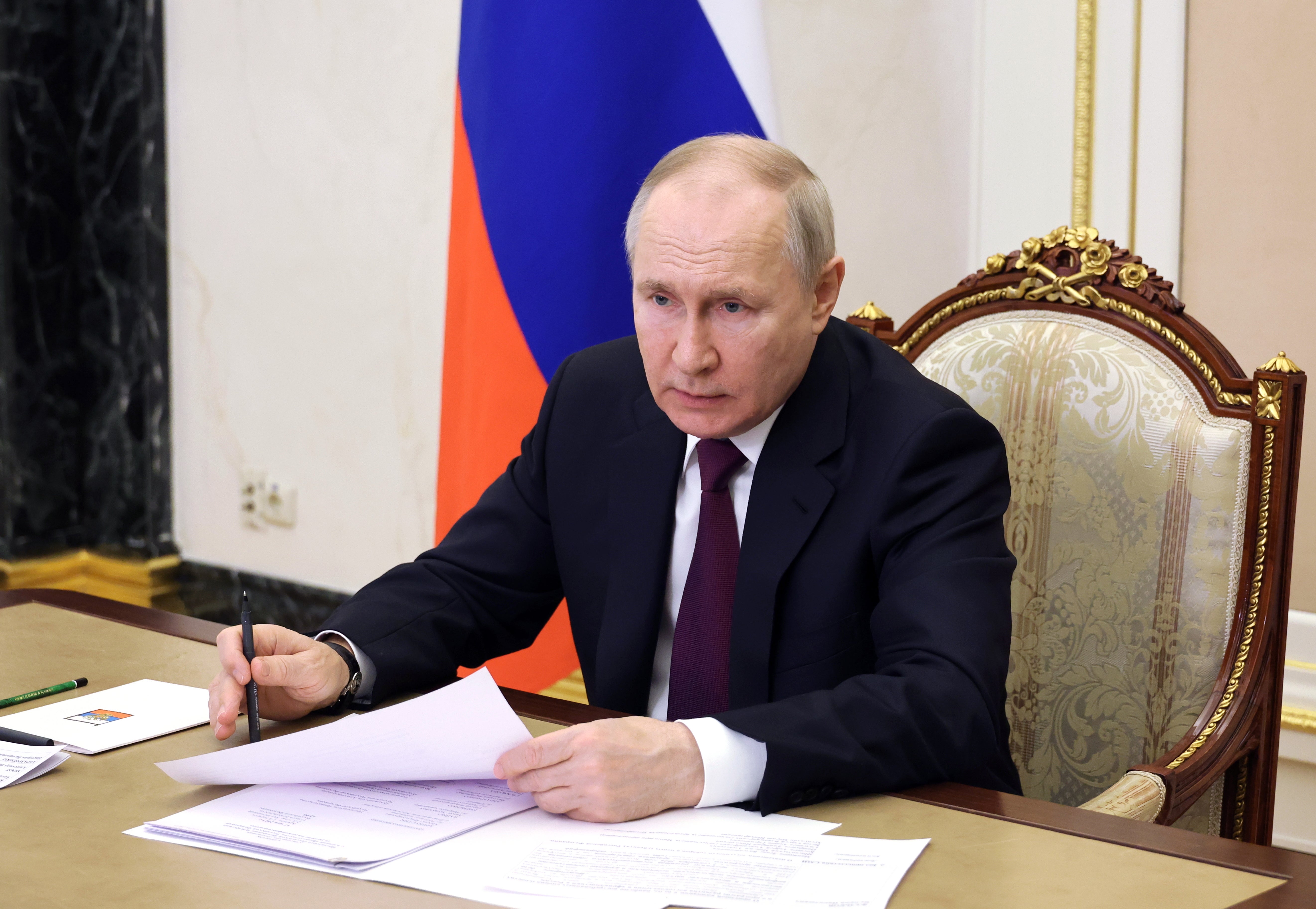 Russian President Vladimir Putin chairs a meeting with members of the government, via a video conference