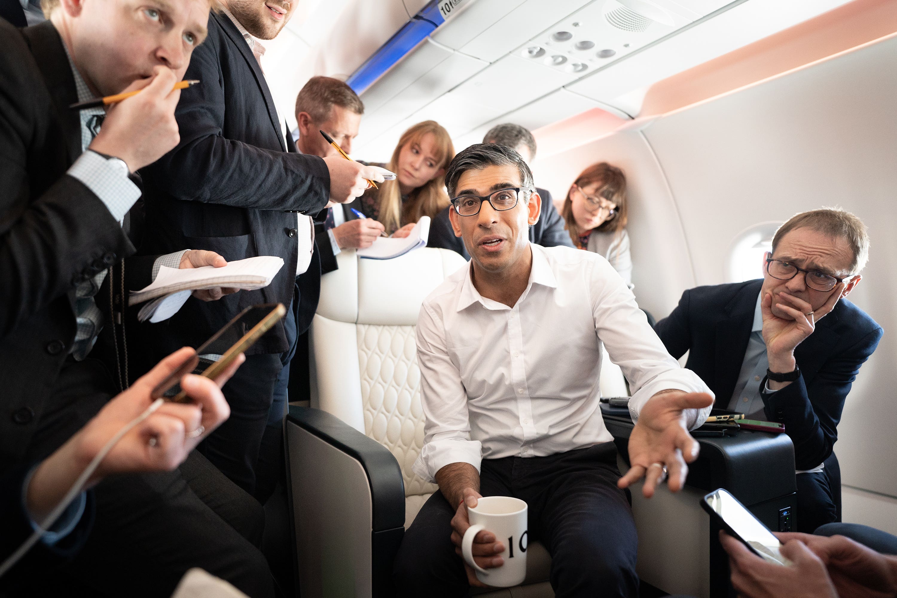 Prime Minister Rishi Sunak holds a huddle with political journalists on board a government plane (Stefan Rousseau/PA)