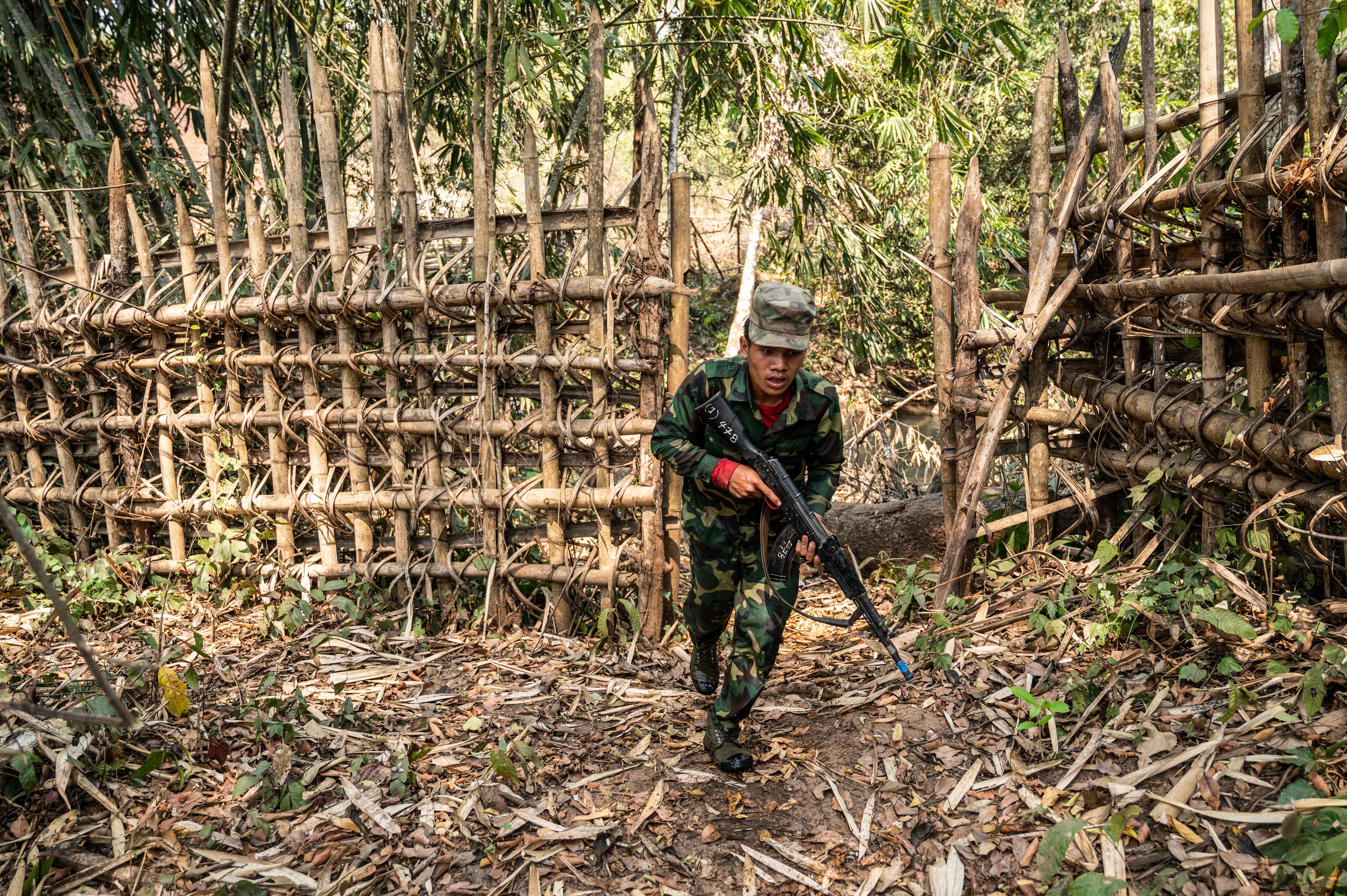 a member of ethnic rebel group Ta’ang National Liberation Army (TNLA) takes part in a training exercise at his base camp in the forest in Myanmar