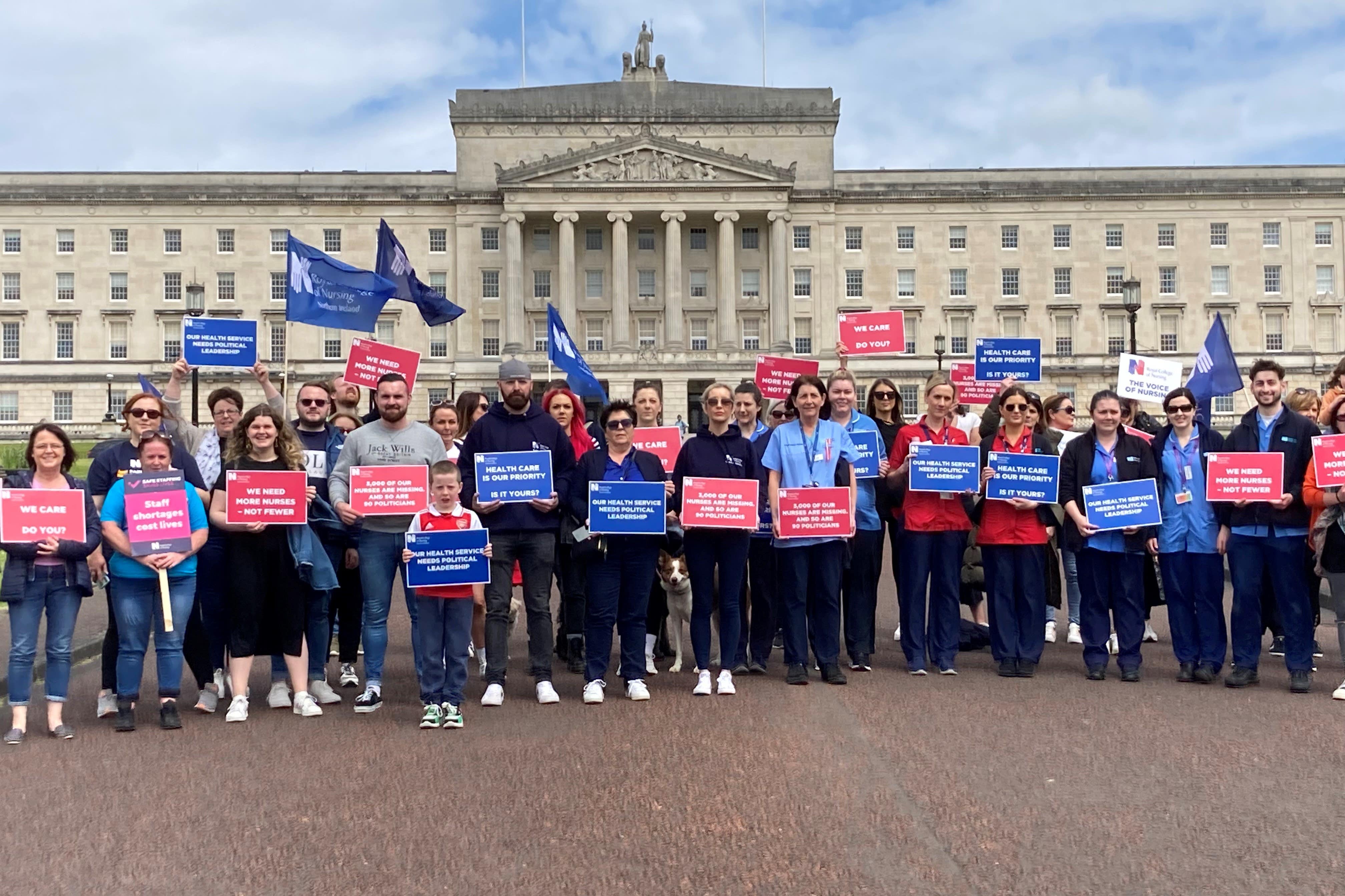 Members of the Royal College of Nursing walked to Parliament Buildings holding placards (Rebecca Black/PA)