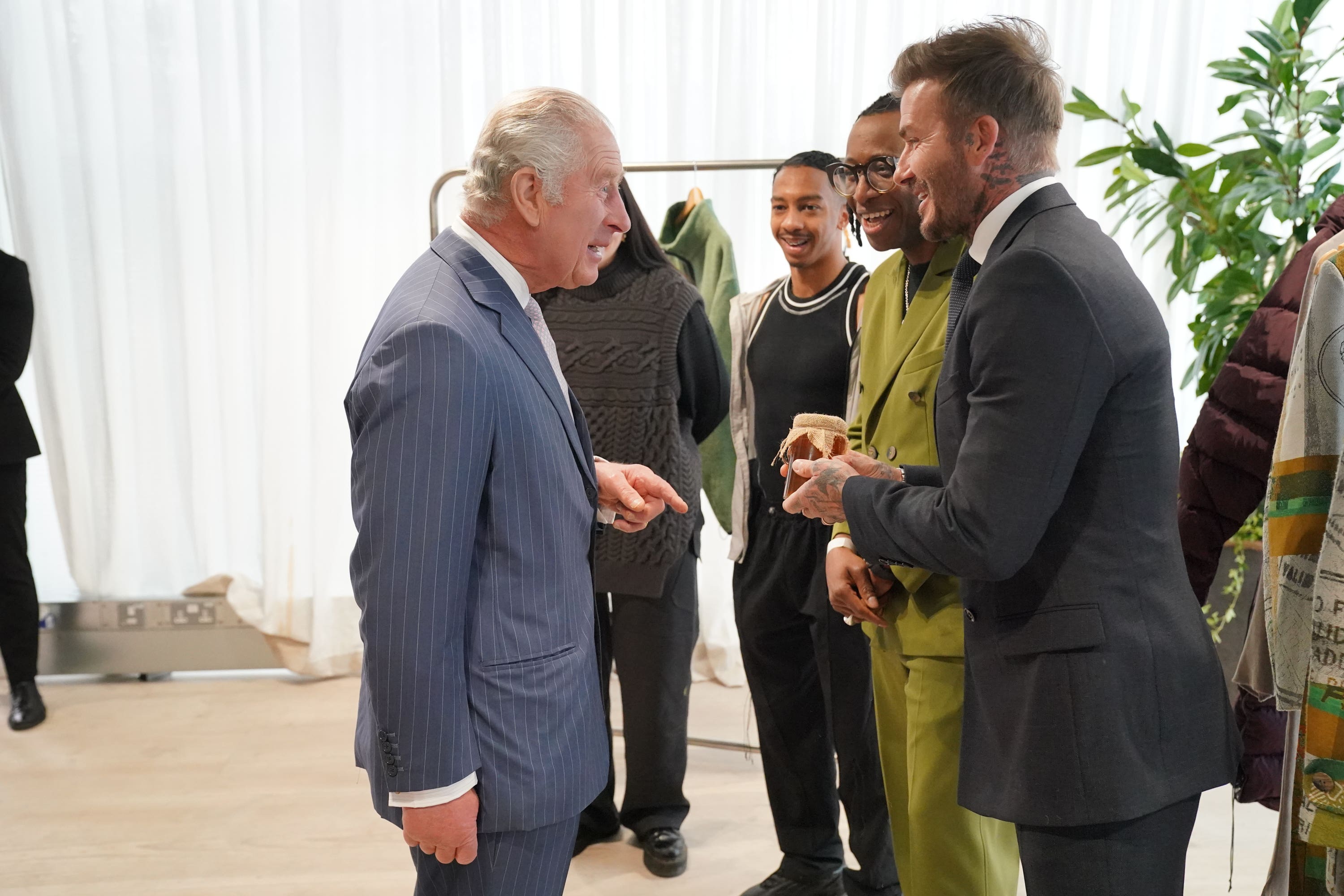 David Beckham offers the King a jar of honey (Jonathan Brady/PA)