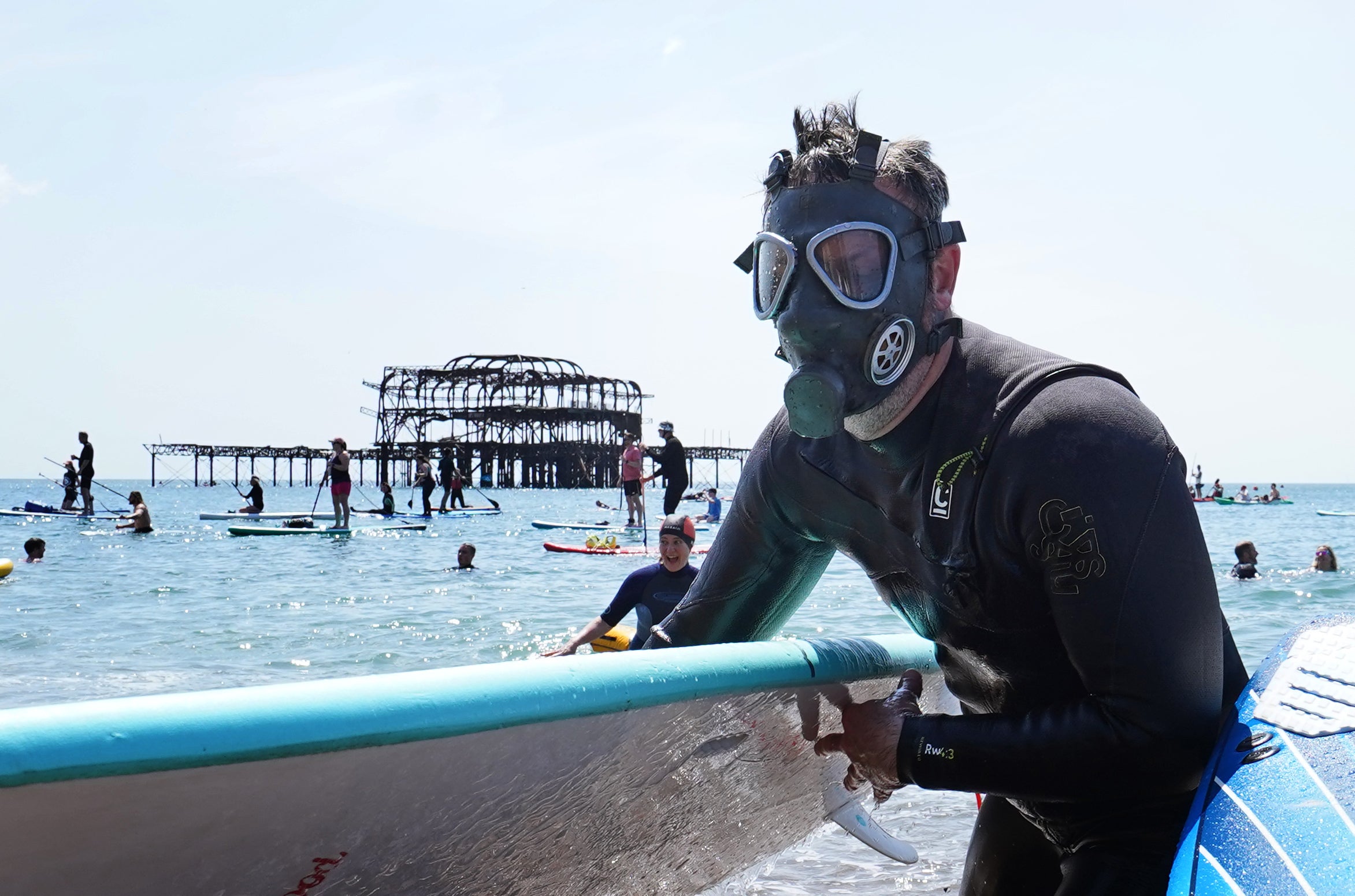 Protesters emerge from the sea as Surfers Against Sewage hold a UK-wide paddle-out protest at Brighton West Pier in East Sussex, as Surfers Against Sewage hold a UK-wide paddle-out protest at Brighton West Pier