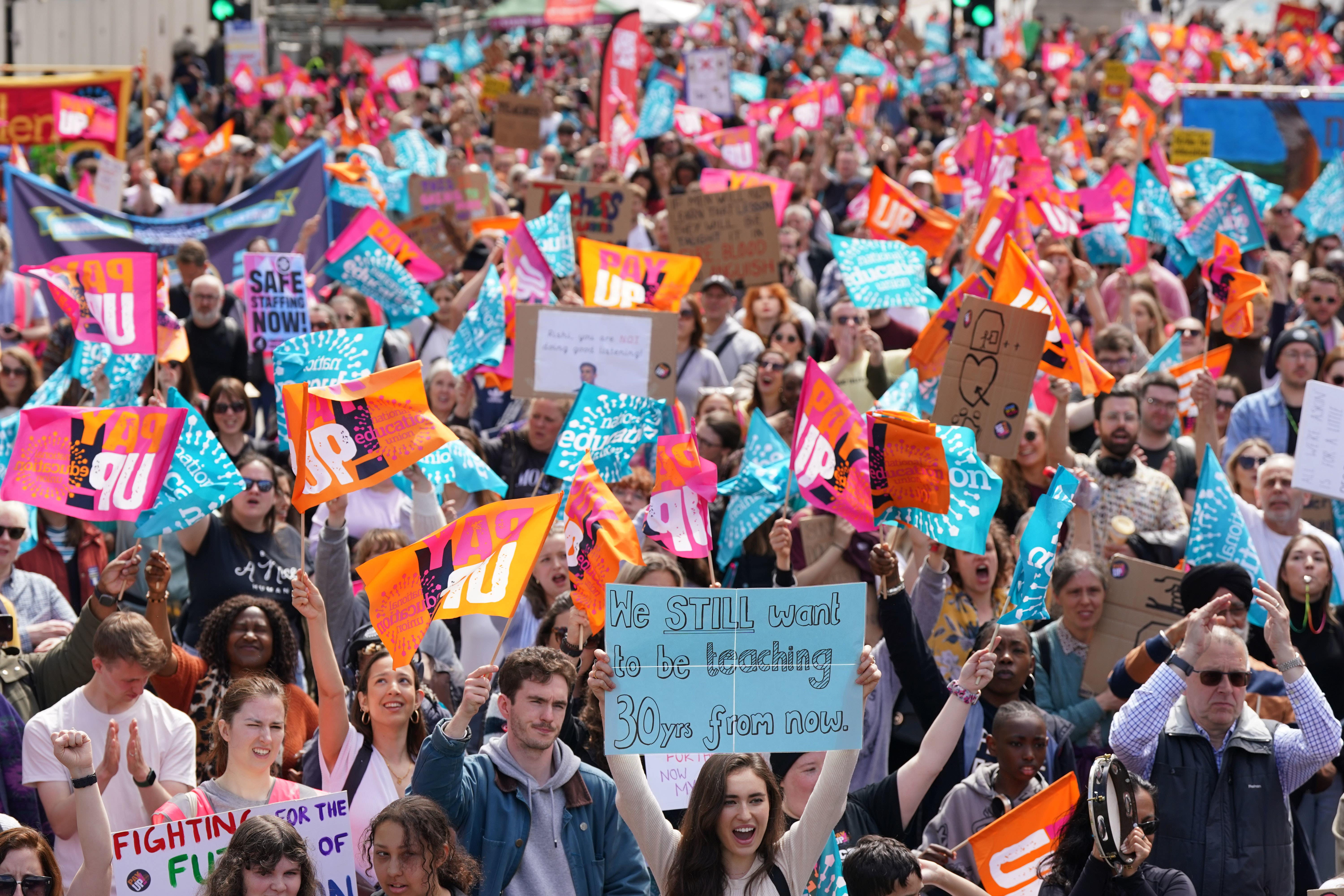 People listen to Kevin Courtney, Joint General Secretary National Education Union (NEU) speaking at a rally in Westminster, London, as they stage walkouts across England in an ongoing dispute over pay (Yui Mok/PA)