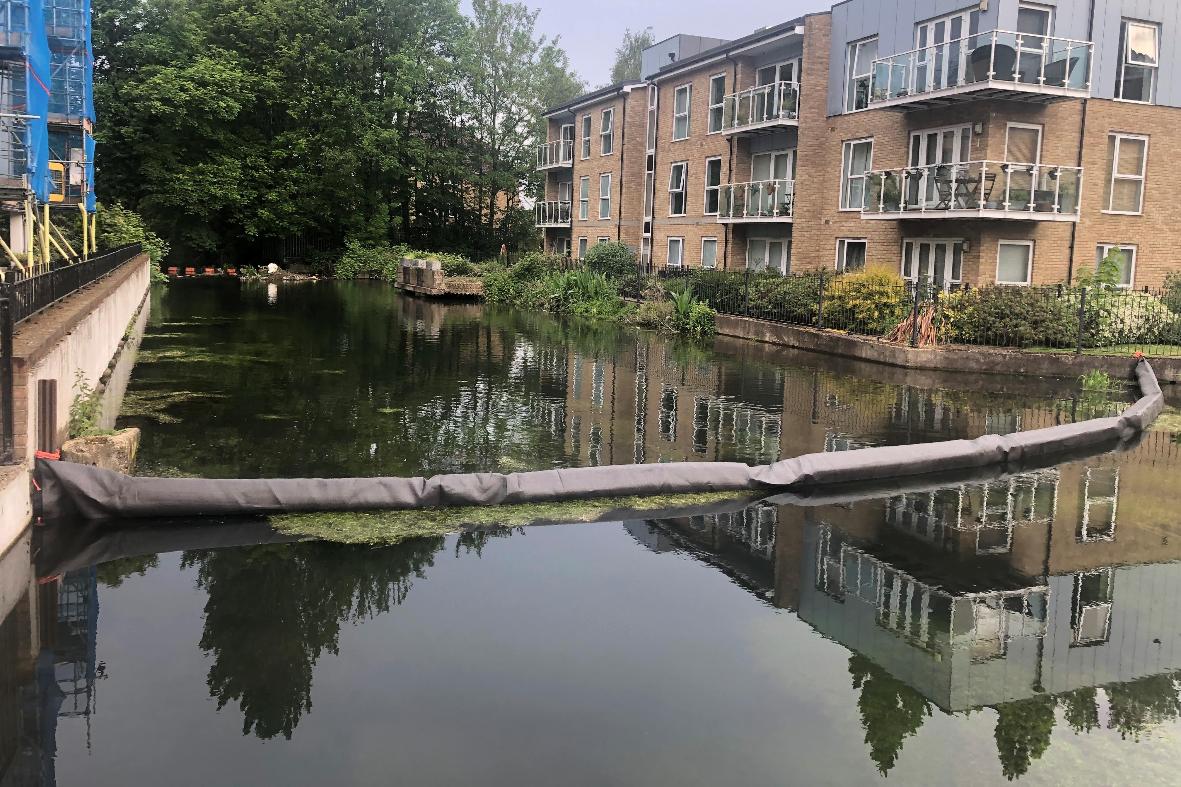 A boom installed in a millpond in Nash Mills (Brian Farmer/PA)