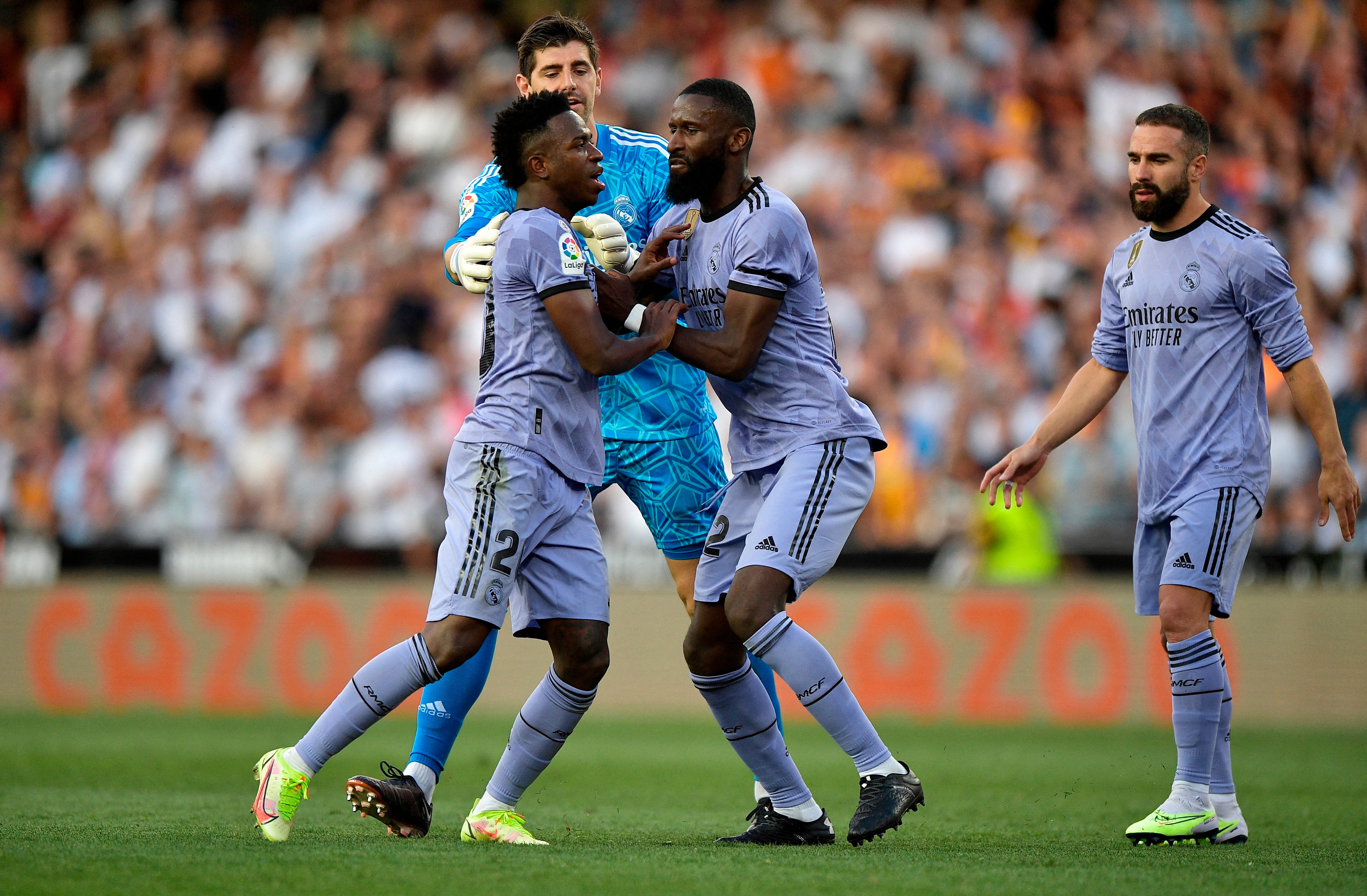 Real Madrid’s Vinicius Junior is restrained by Antonio Rudiger and Thibaut Courtois after being sent off