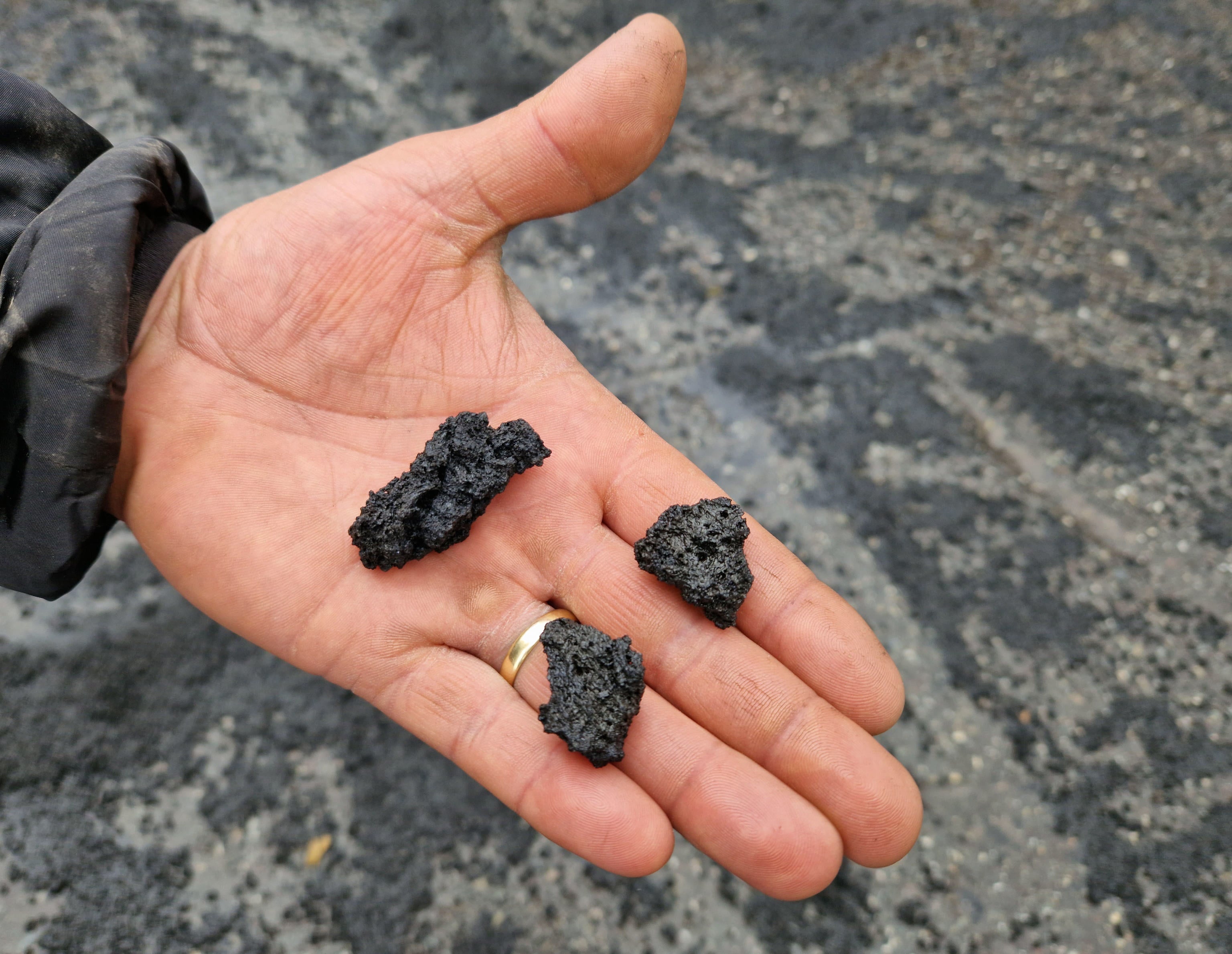 A person shows copious volcanic ash due to the eruptive activity of Etna on Sunday