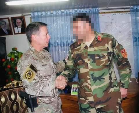 The Afghan colonel shakes hands with four-star US general and then head of Nato forces in Afghanistan, Austin Scott Miller