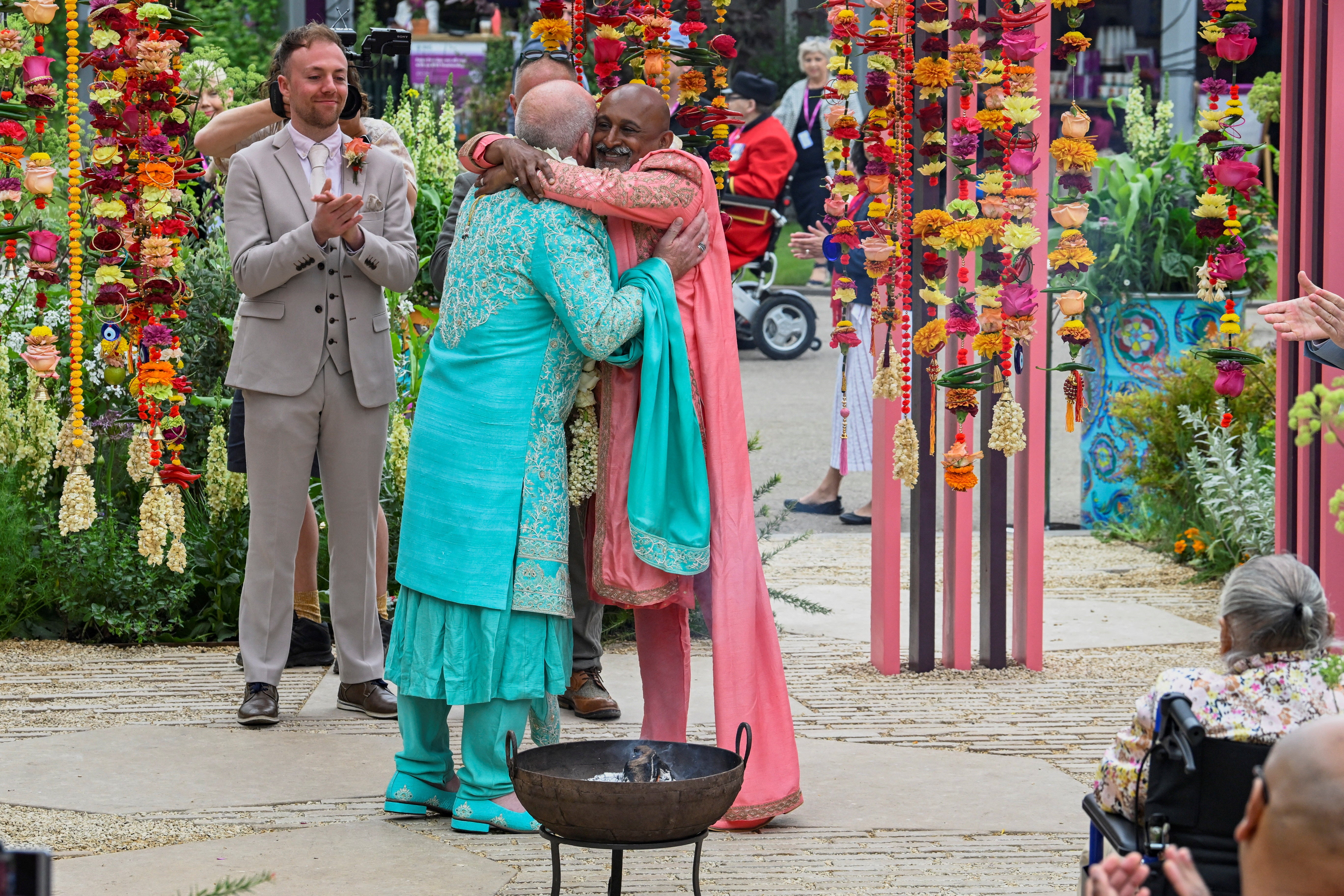 Manoj Malde and Clive Gillmor hug as they get married in a civil wedding ceremony at the RHS and Eastern Eye Garden of Unity, the first wedding to take place at Chelsea Flower Show in London