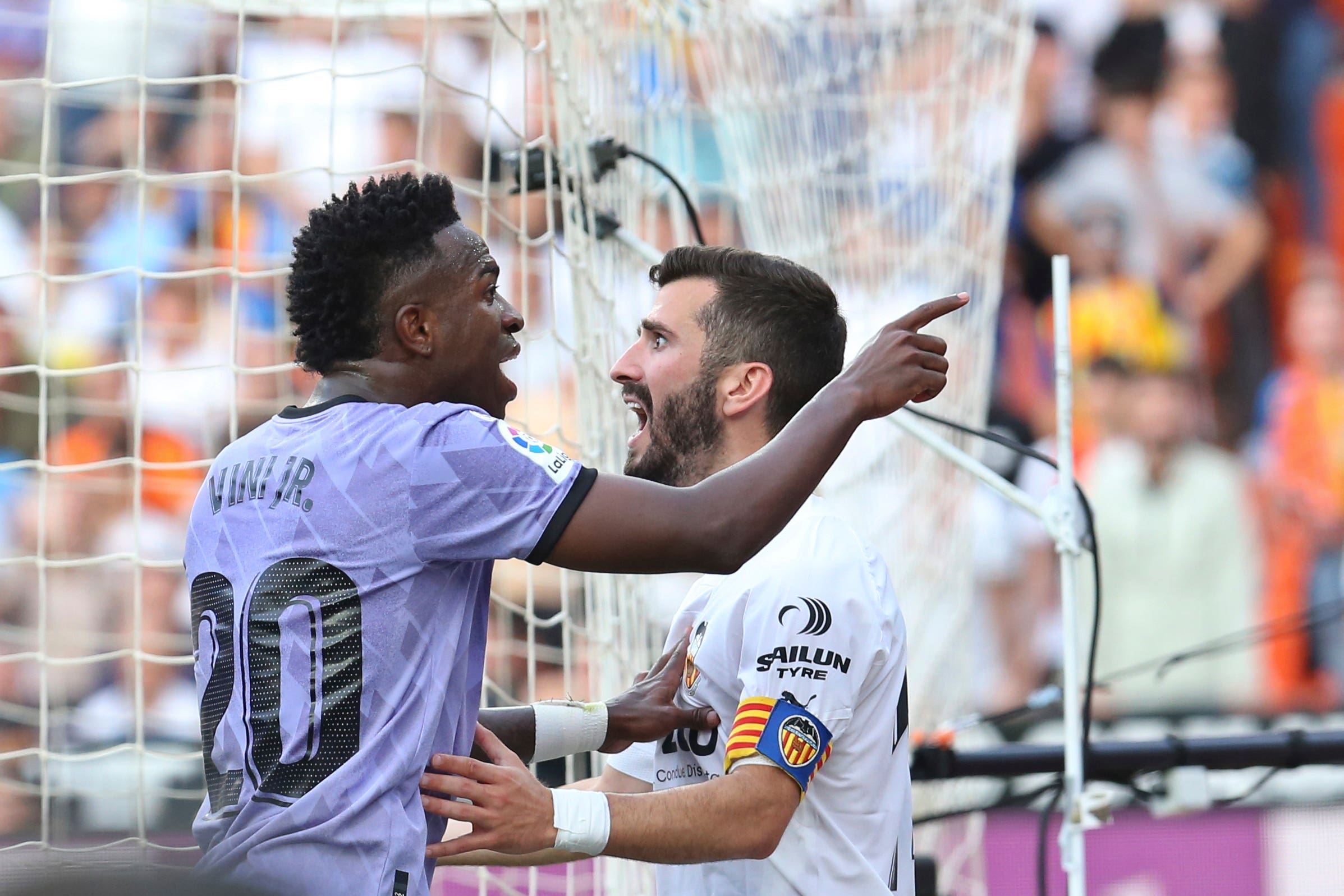 Real Madrid forward Vinicius Junior, left, confronts Valencia fans after being the alleged target of racial abuse on Sunday (Alberto Saiz/AP)