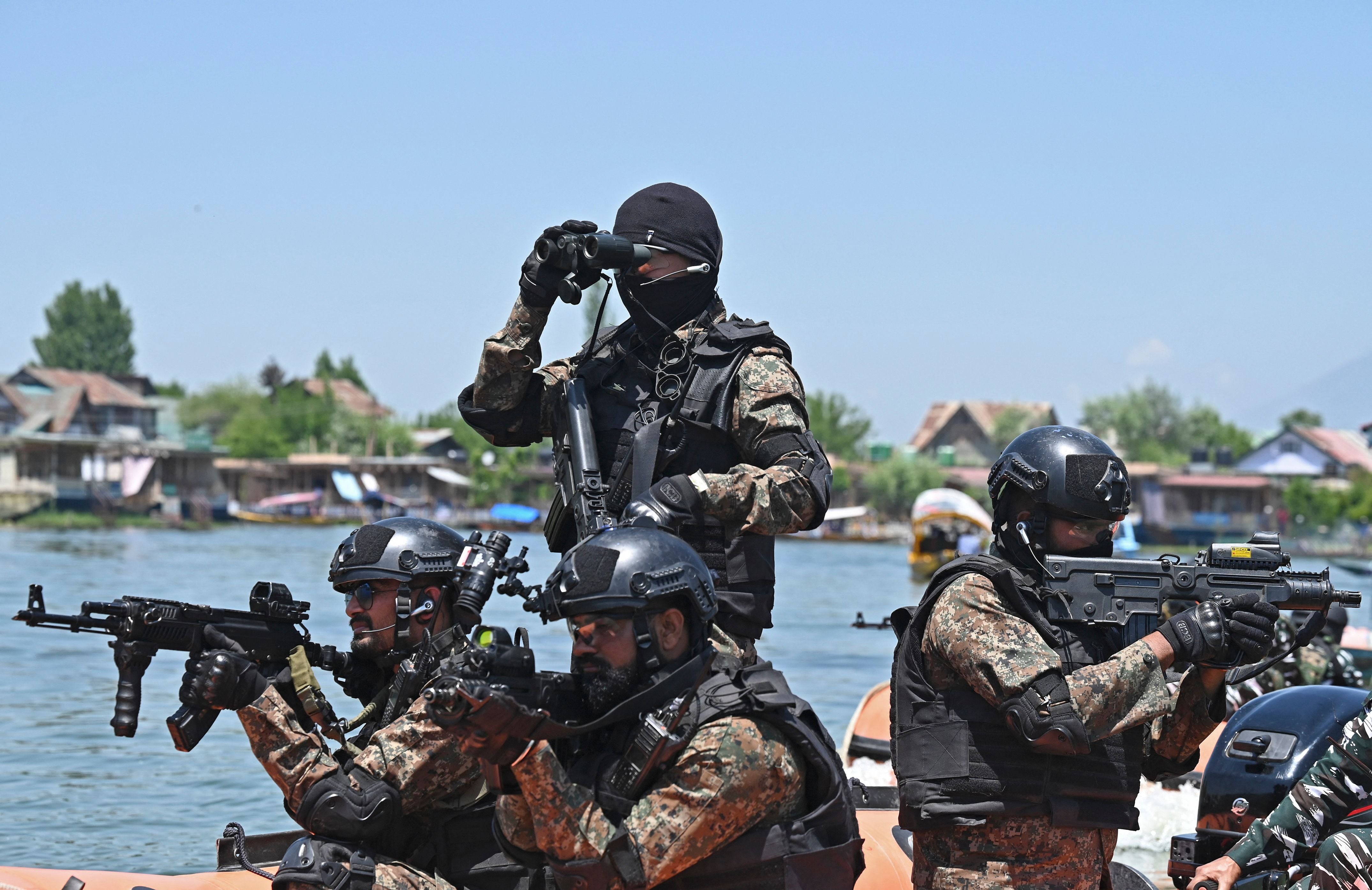 Indian paramilitary trooper commandoes conduct a special security drill at Dal Lake in Srinagar